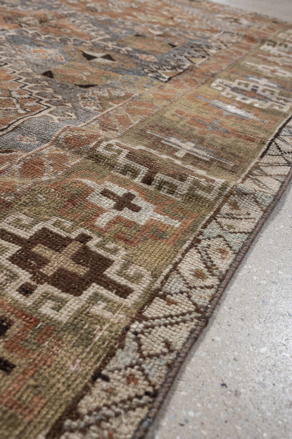 4' x 6' one-of-a-kind handmade antique Shiraz rug. Color palette: terra cotta, sage, ivory, charcoal, taupe, slate, camel