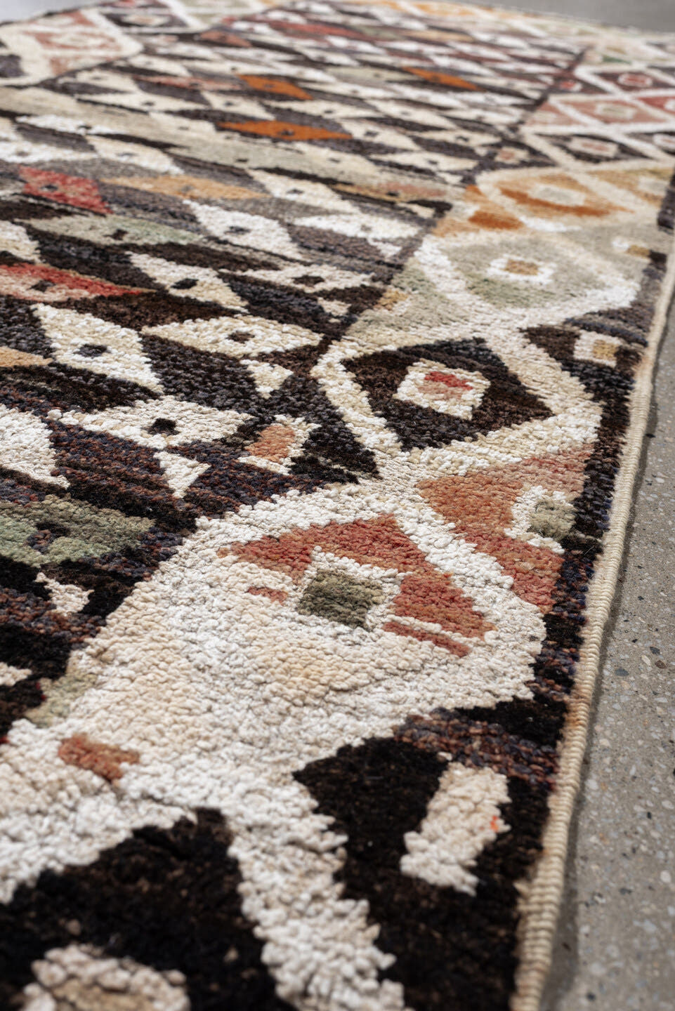 3' x 9' one-of-a-kind handmade vintage Kars runner rug. Color palette: dark brown, ivory, sage, rust, coral, taupe, charcoal