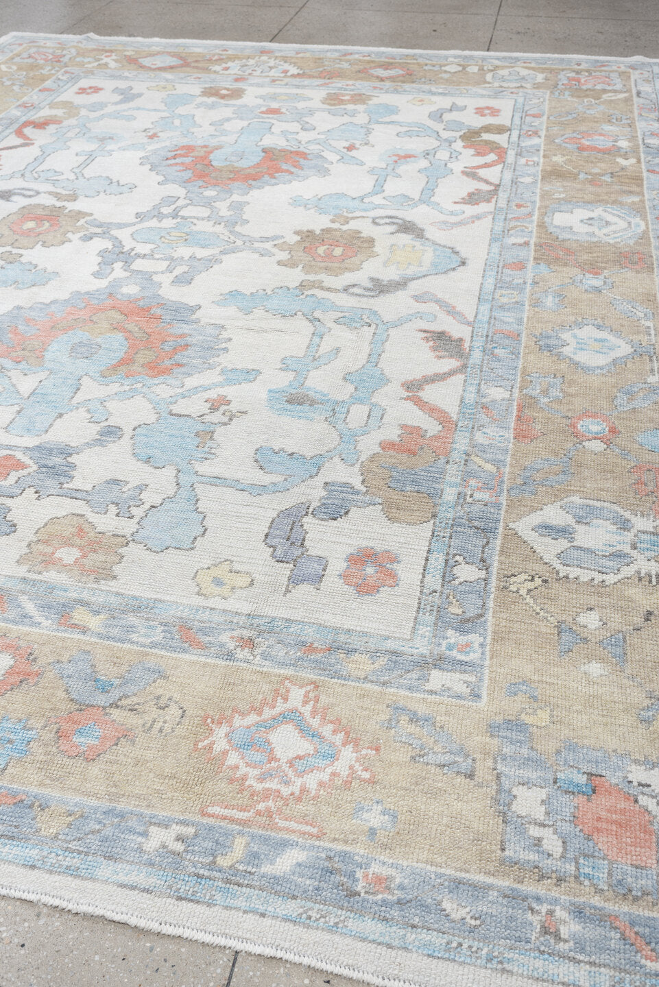9' x 12' one-of-a-kind handmade vintage Oushak large size rug. Color palette: ivory, powder blue, taupe, coral, pale blue