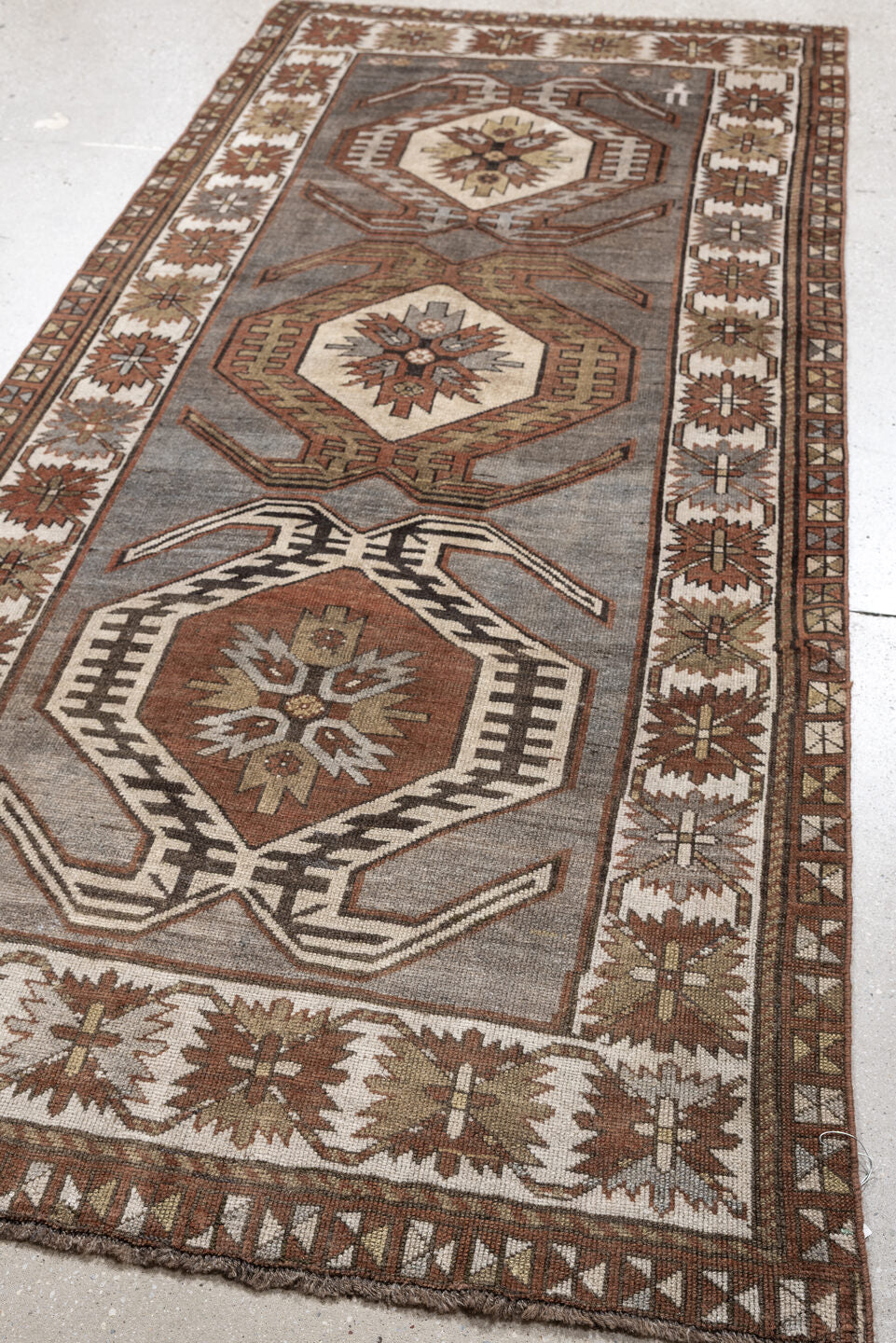 3' x 7' one-of-a-kind handmade antique Caucasian runner rug. Color palette: charcoal, ivory, rust, taupe, dark brown, camel