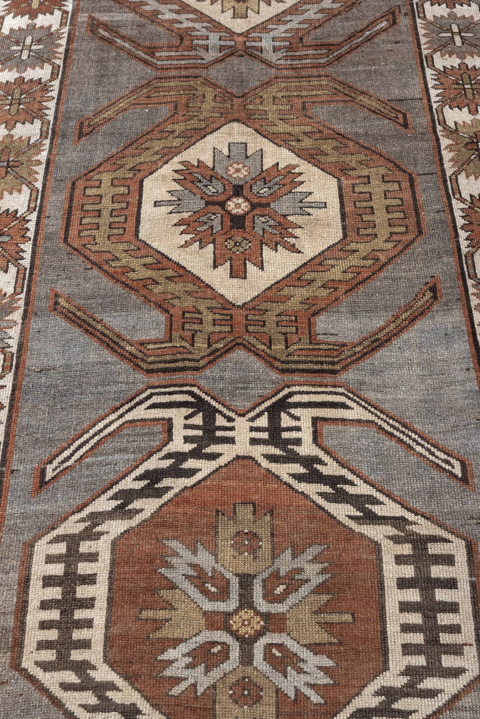 3' x 7' one-of-a-kind handmade antique Caucasian runner rug. Color palette: charcoal, ivory, rust, taupe, dark brown, camel