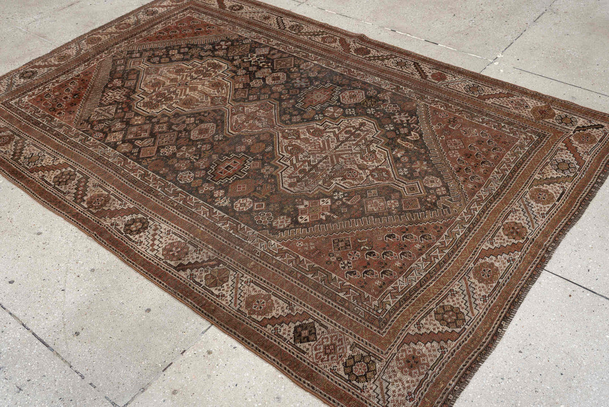 4' x 6' one-of-a-kind handmade antique Shiraz rug. Color palette: brown, rust, ivory, terracotta, charcoal, camel, sage