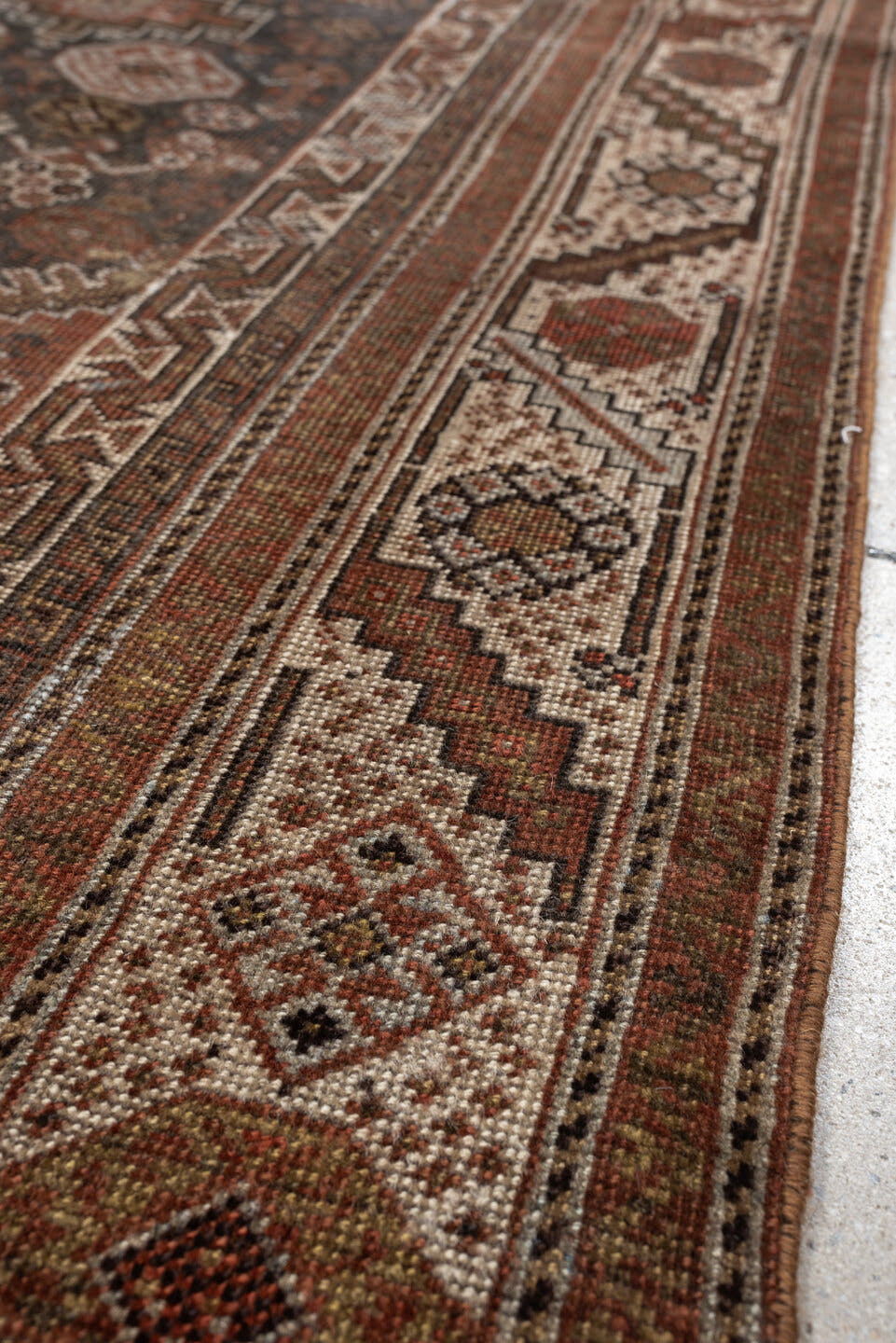 4' x 6' one-of-a-kind handmade antique Shiraz rug. Color palette: brown, rust, ivory, terracotta, charcoal, camel, sage