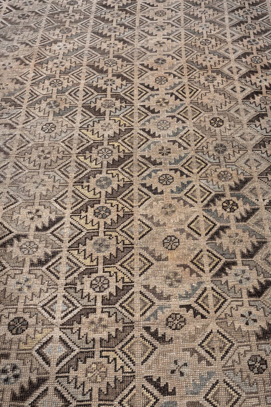 7' x 9' one-of-a-kind handmade antique Shiraz rug. Color palette: taupe, ivory, charcoal, brown, gray, cream, ebony, beige