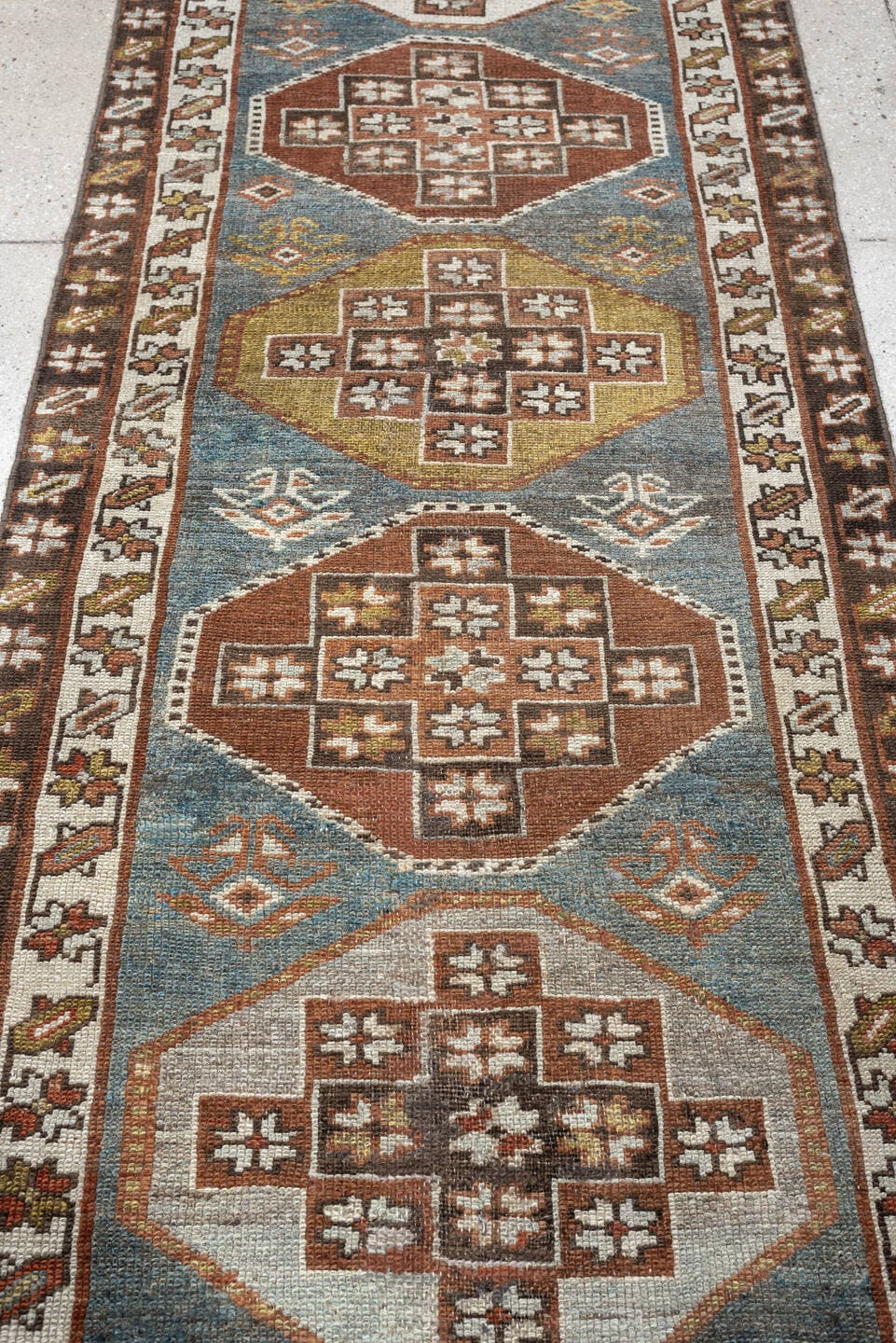 2' x 12' one-of-a-kind handmade antique Kurd runner rug. Color palette: blue green, rust, ivory, dark brown, ochre, olive