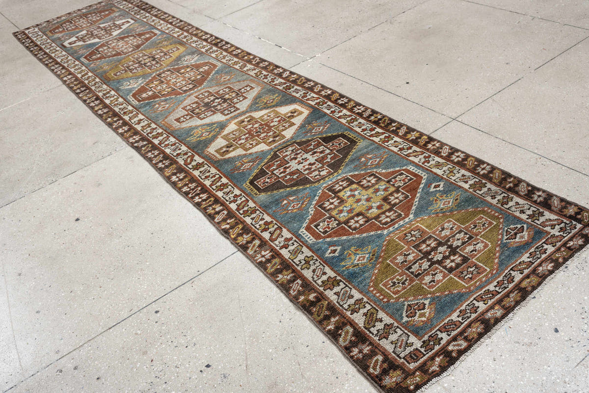 2' x 12' one-of-a-kind handmade antique Kurd runner rug. Color palette: blue green, rust, ivory, dark brown, ochre, olive