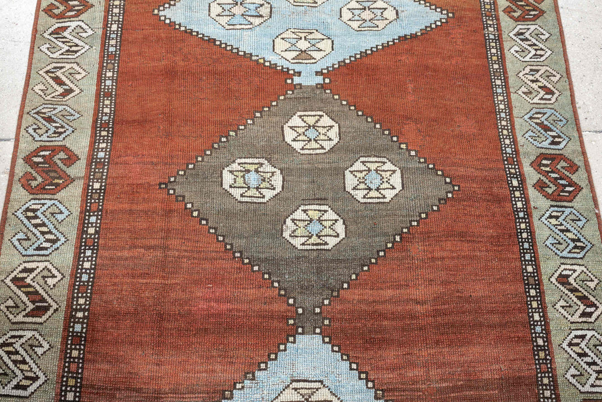 3' x 10' one-of-a-kind handmade antique Kurd runner rug. Color palette: rust, terra cotta, pale blue, taupe, ivory, sage