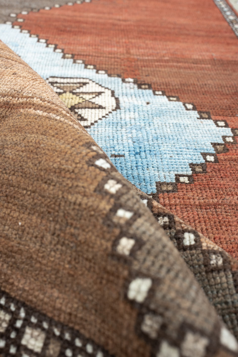 3' x 10' one-of-a-kind handmade antique Kurd runner rug. Color palette: rust, terra cotta, pale blue, taupe, ivory, sage