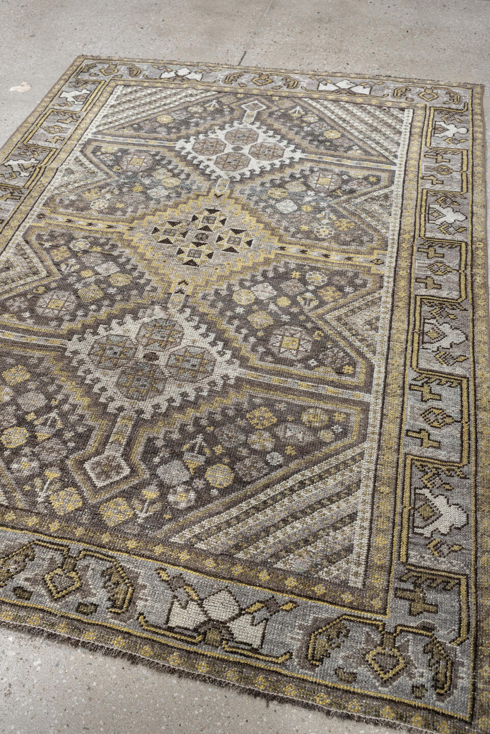 4' x 5' one-of-a-kind handmade antique Shiraz small size rug. Color palette: taupe, charcoal, ivory, soft gold, gray, brown