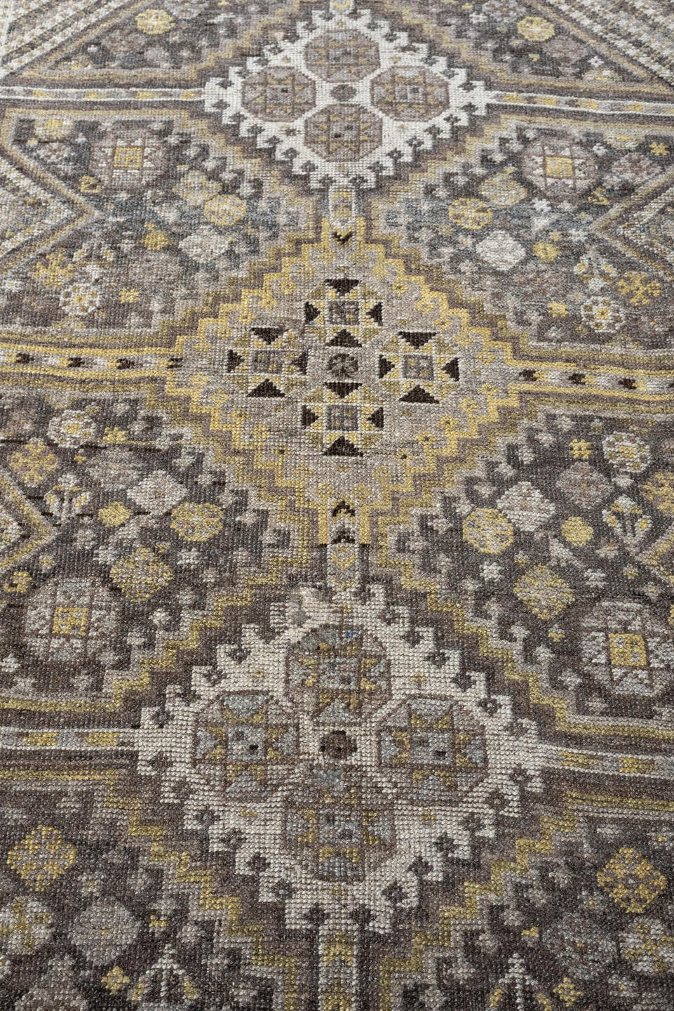 4' x 5' one-of-a-kind handmade antique Shiraz small size rug. Color palette: taupe, charcoal, ivory, soft gold, gray, brown