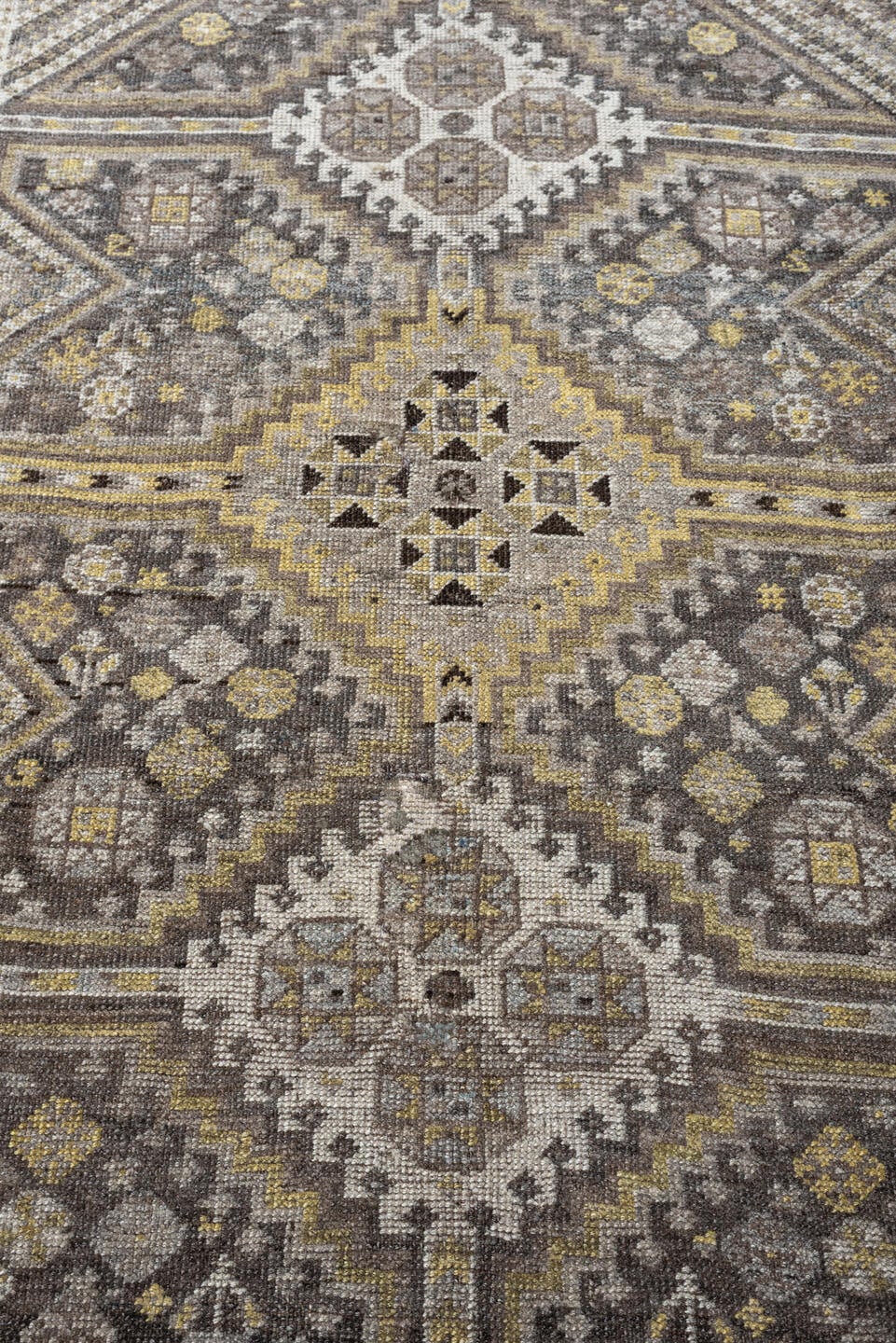 4' x 5' one-of-a-kind handmade antique Shiraz small size rug. Color palette: taupe, charcoal, ivory, soft gold, gray, brown