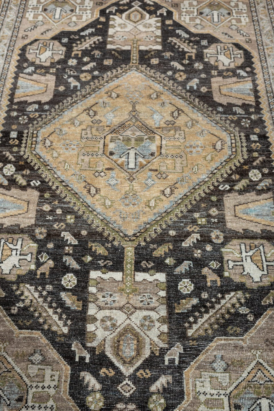 4' x 6' one-of-a-kind handmade antique Shiraz rug. Color palette: ivory, charcoal, camel, taupe, pale blue, olive, sand