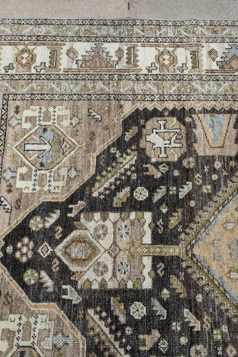 4' x 6' one-of-a-kind handmade antique Shiraz rug. Color palette: ivory, charcoal, camel, taupe, pale blue, olive, sand