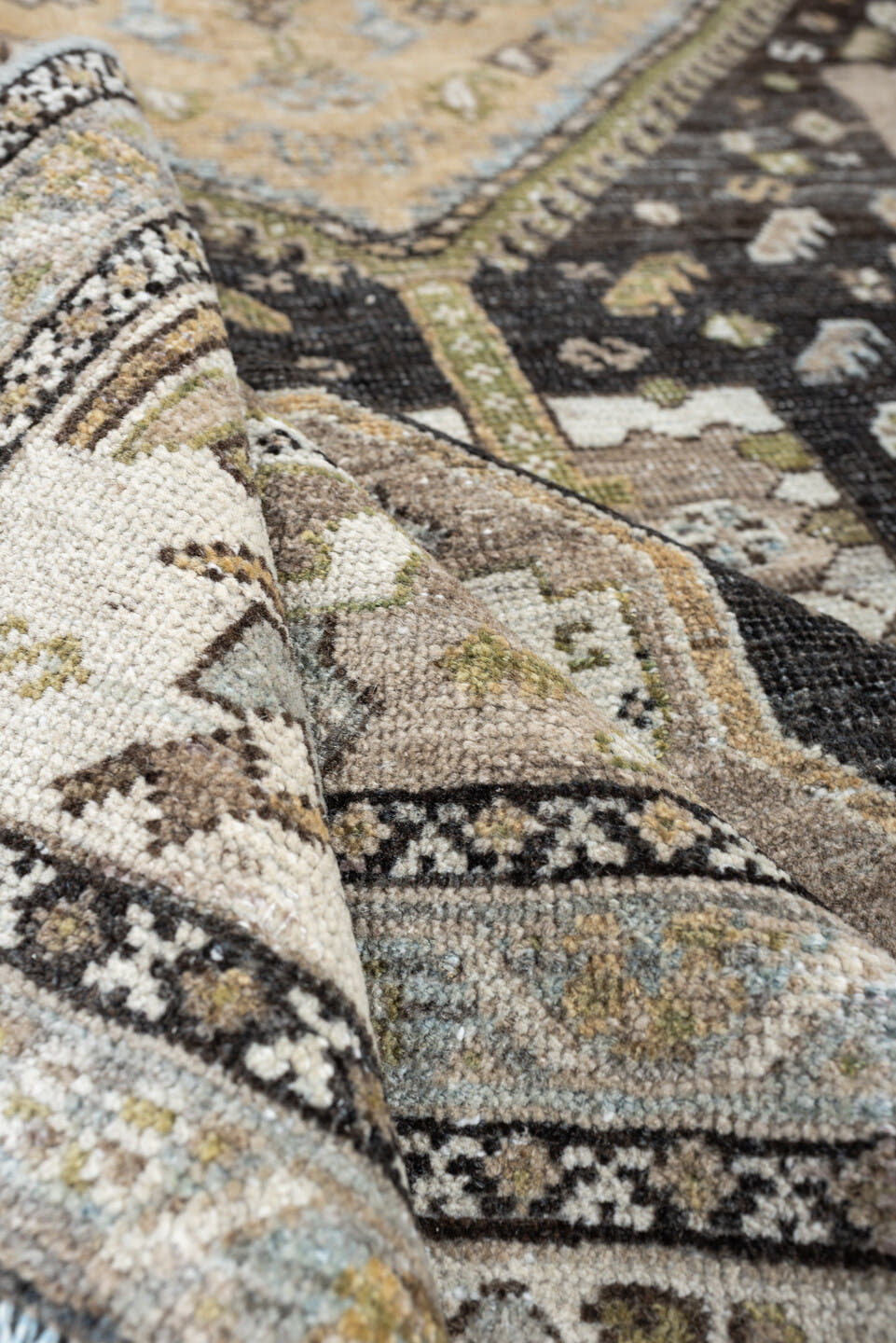 4' x 6' one-of-a-kind handmade antique Shiraz rug. Color palette: ivory, charcoal, camel, taupe, pale blue, olive, sand