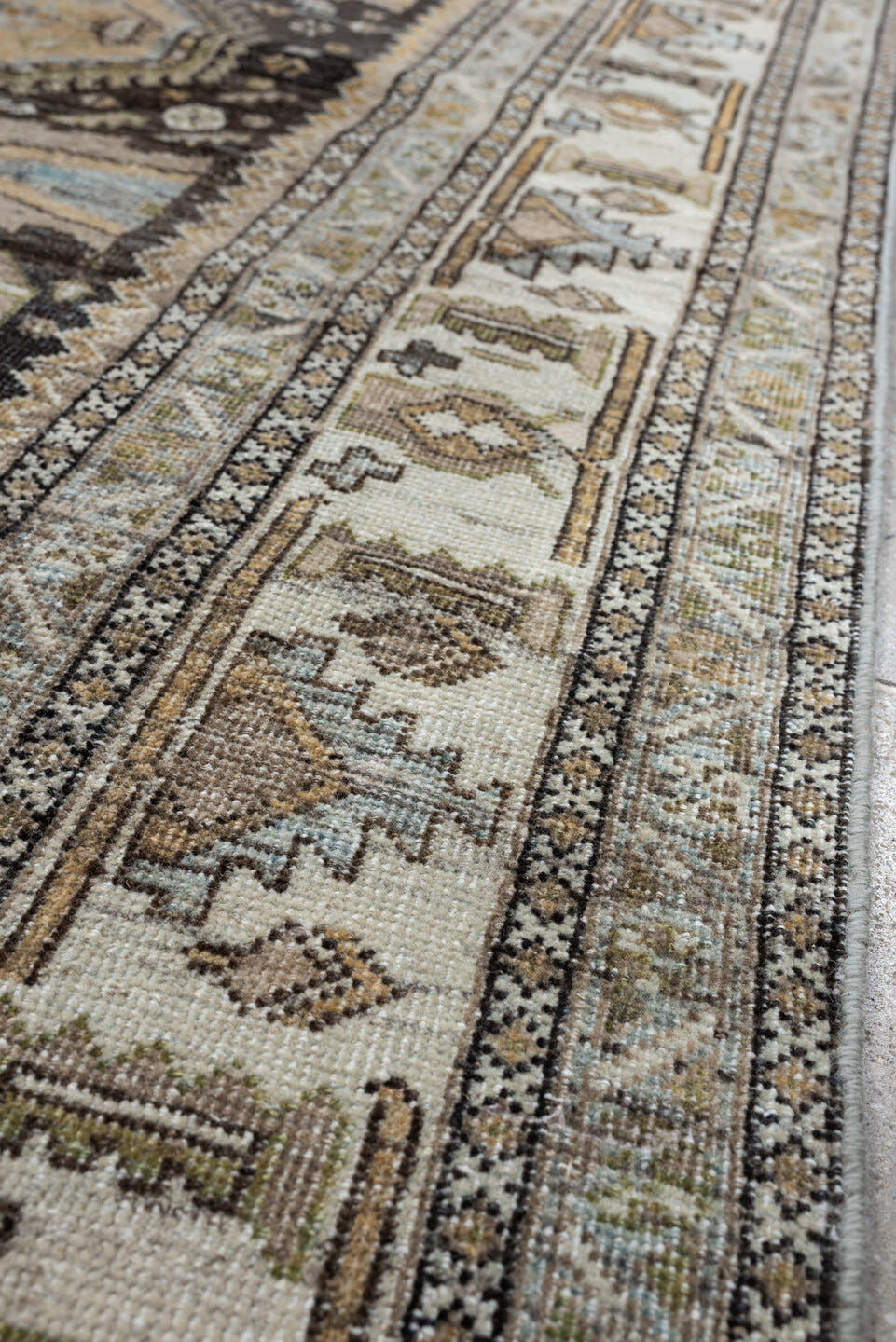 4' x 6' one-of-a-kind handmade antique Shiraz rug. Color palette: ivory, charcoal, camel, taupe, pale blue, olive, sand