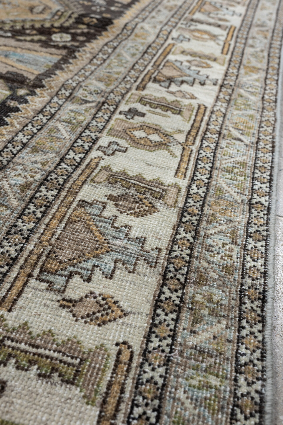 4' x 6' one-of-a-kind handmade antique Shiraz rug. Color palette: ivory, charcoal, camel, taupe, pale blue, olive, sand