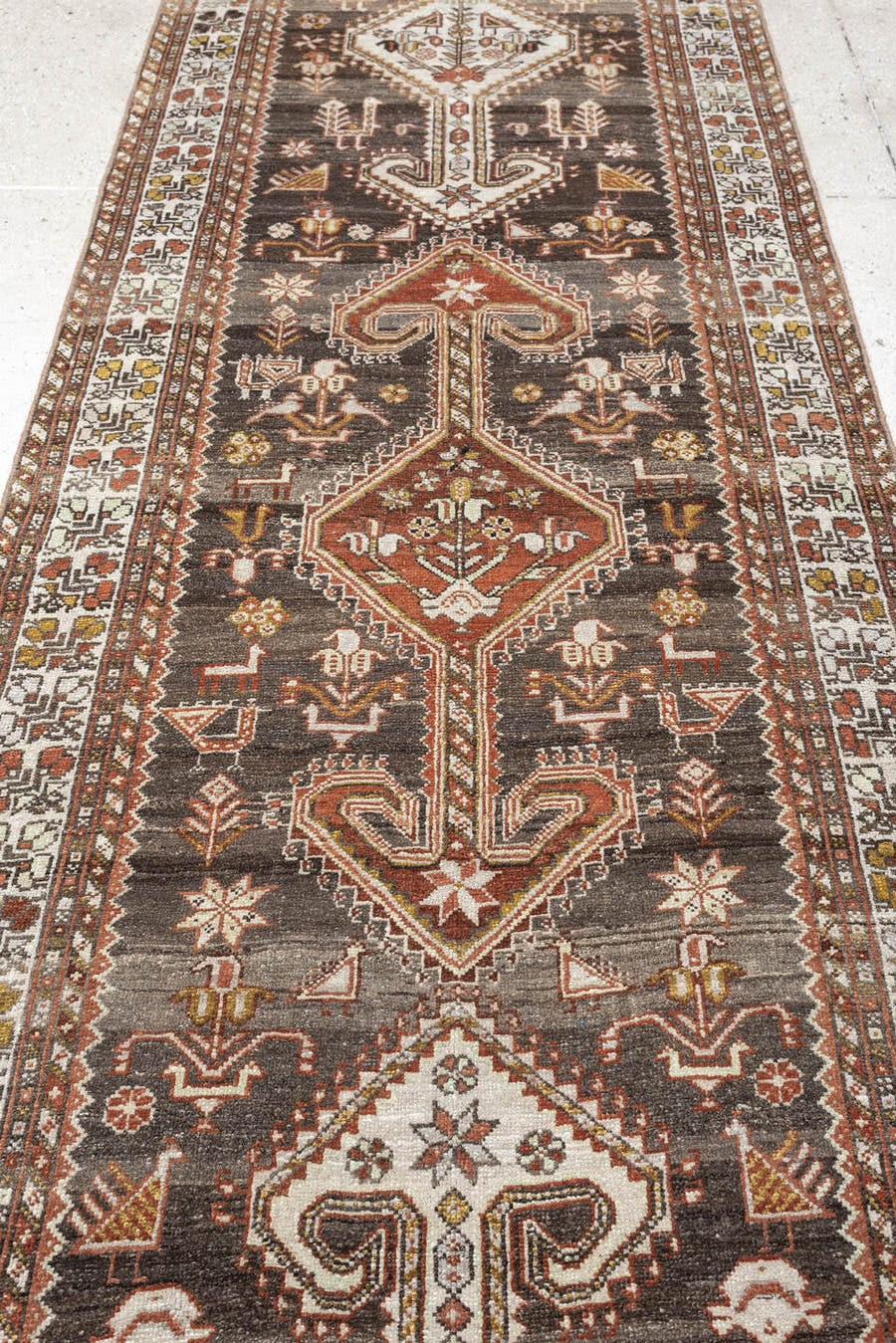3' x 12' one-of-a-kind handmade antique Shiraz runner rug. Color palette: dark brown, ivory, rust, terra cotta, charcoal