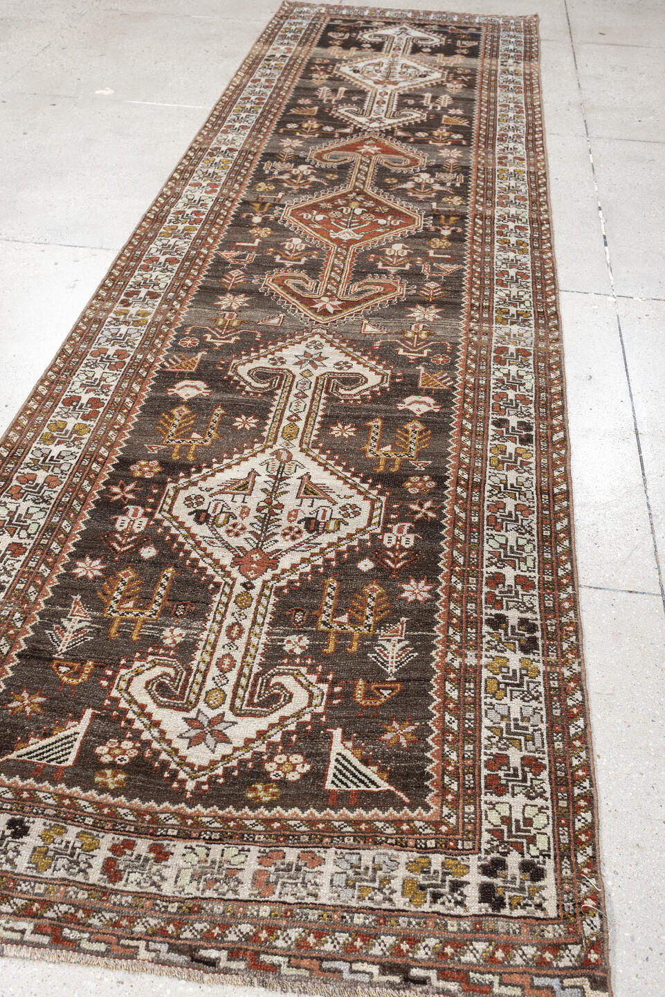 3' x 12' one-of-a-kind handmade antique Shiraz runner rug. Color palette: dark brown, ivory, rust, terra cotta, charcoal