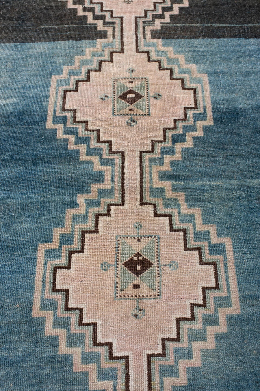 4' x 7' one-of-a-kind handmade antique Shiraz rug. Color palette: teal blue, ivory, blush, charcoal, slate blue, dark brown