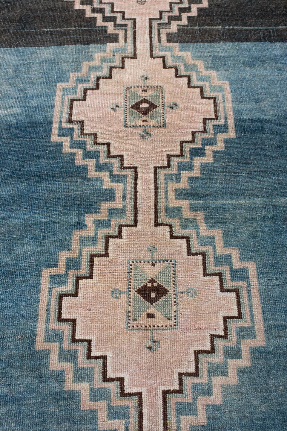 4' x 7' one-of-a-kind handmade antique Shiraz rug. Color palette: teal blue, ivory, blush, charcoal, slate blue, dark brown