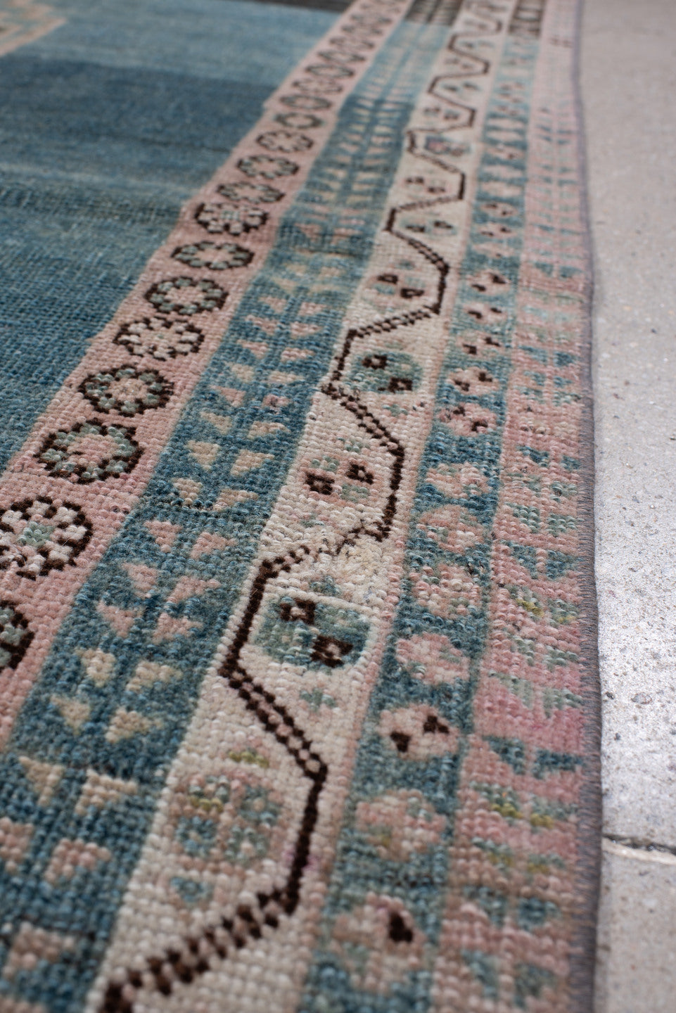 4' x 7' one-of-a-kind handmade antique Shiraz rug. Color palette: teal blue, ivory, blush, charcoal, slate blue, dark brown