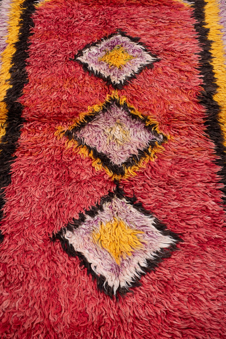 4' x 8' one-of-a-kind handmade antique Tulu rug. Color palette: crimson, dark brown, saffron, lavender, rose, coral, ivory