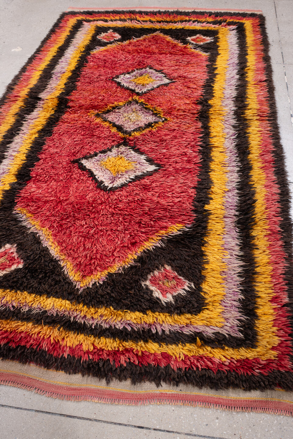 4' x 8' one-of-a-kind handmade antique Tulu rug. Color palette: crimson, dark brown, saffron, lavender, rose, coral, ivory