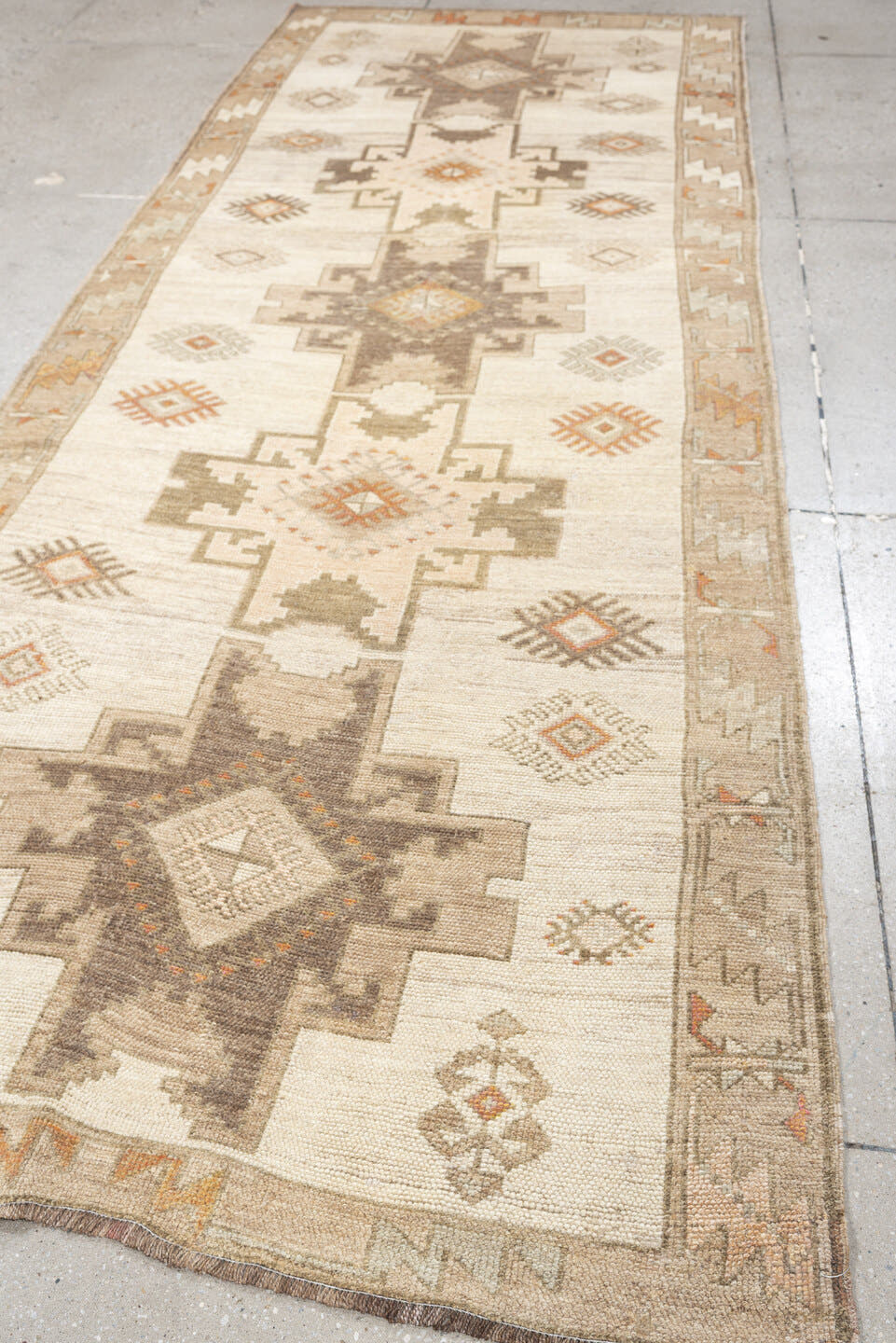 4' x 10' one-of-a-kind handmade antique Anatolian runner rug. Color palette: ivory, taupe, charcoal, camel, coral, rose