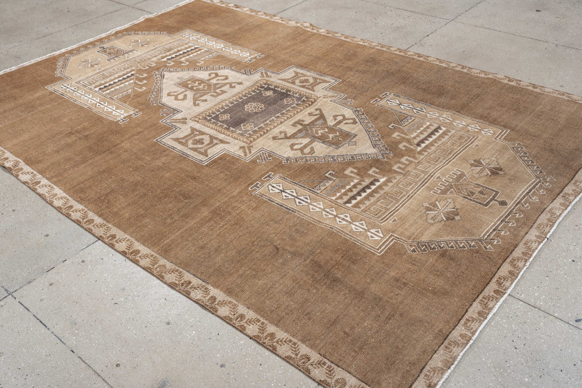 6' x 9' one-of-a-kind handmade antique Kars medium size rug. Color palette: camel, taupe, ivory, brown, charcoal, sand