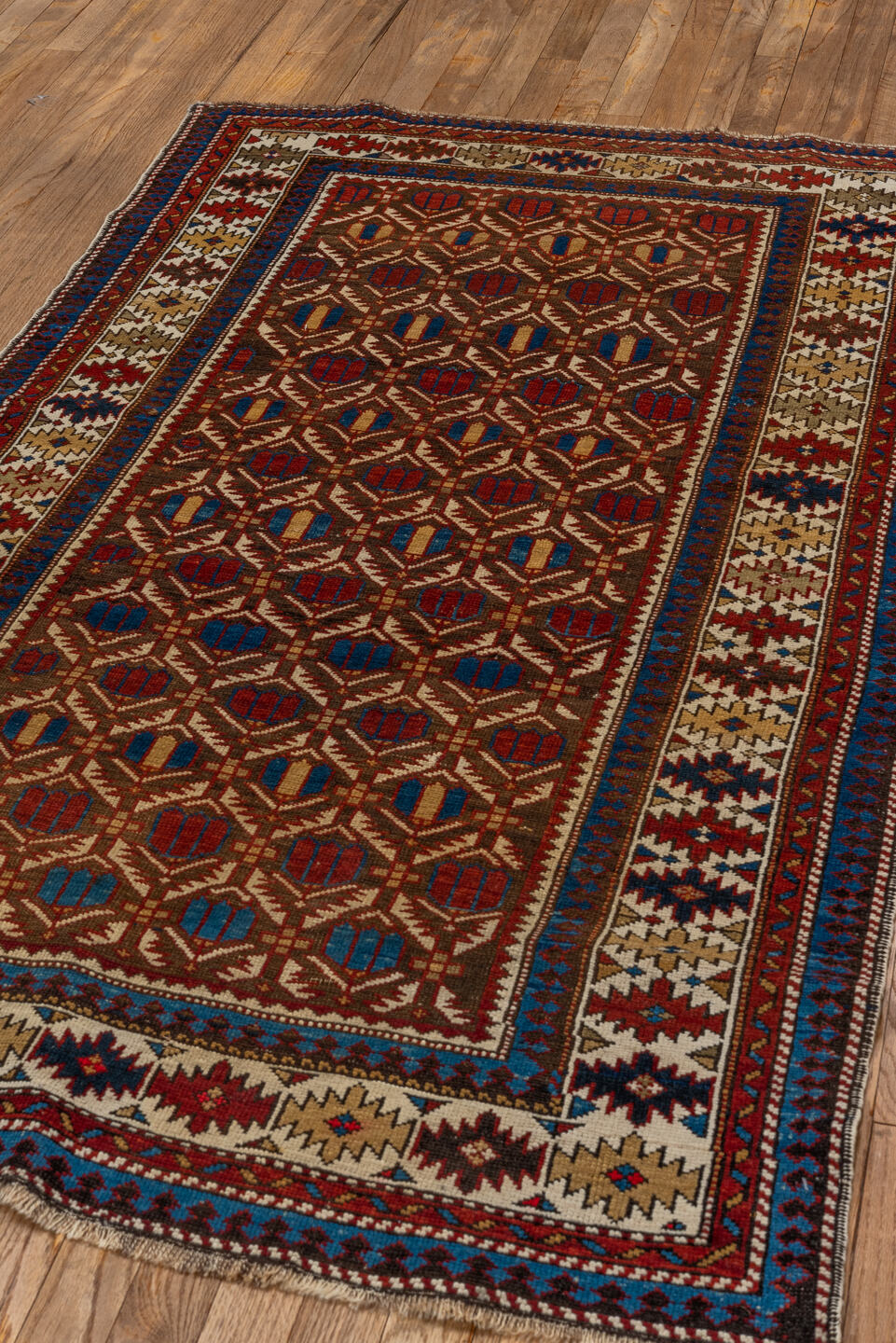 3' x 5' one-of-a-kind handmade vintage Shirvan small size rug. Color palette: ivory, indigo, rust, crimson, brown, camel