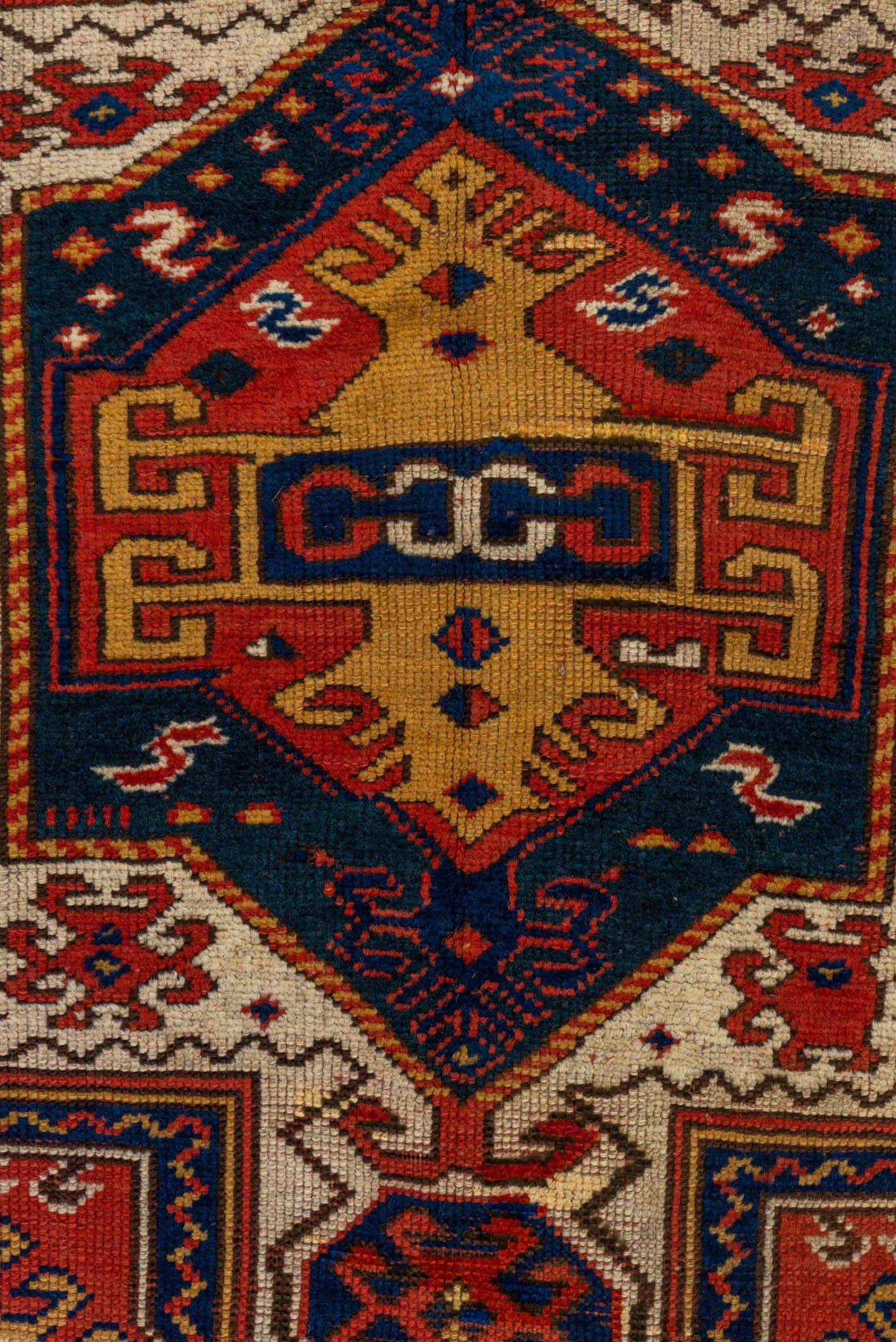 3' x 6' one-of-a-kind handmade vintage Kazak small size rug. Color palette: rust, ivory, navy, gold, crimson, camel, teal