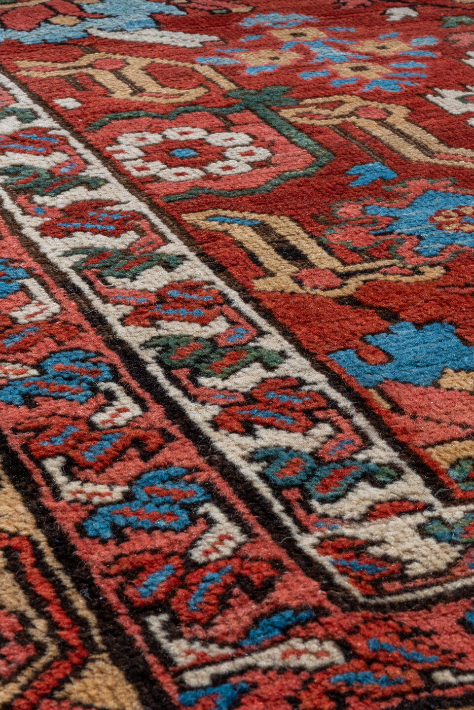 11' x 21' one-of-a-kind handmade antique Serapi oversize rug. Color palette: red, ivory, camel, blue, rose, rust, sage