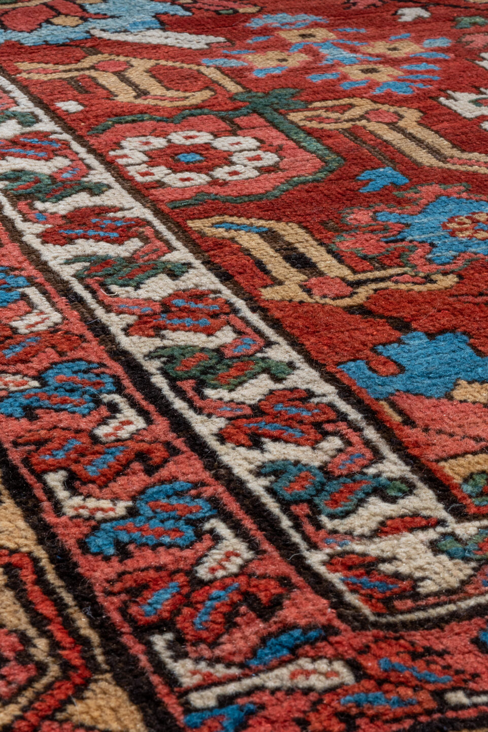 11' x 21' one-of-a-kind handmade antique Serapi oversize rug. Color palette: red, ivory, camel, blue, rose, rust, sage