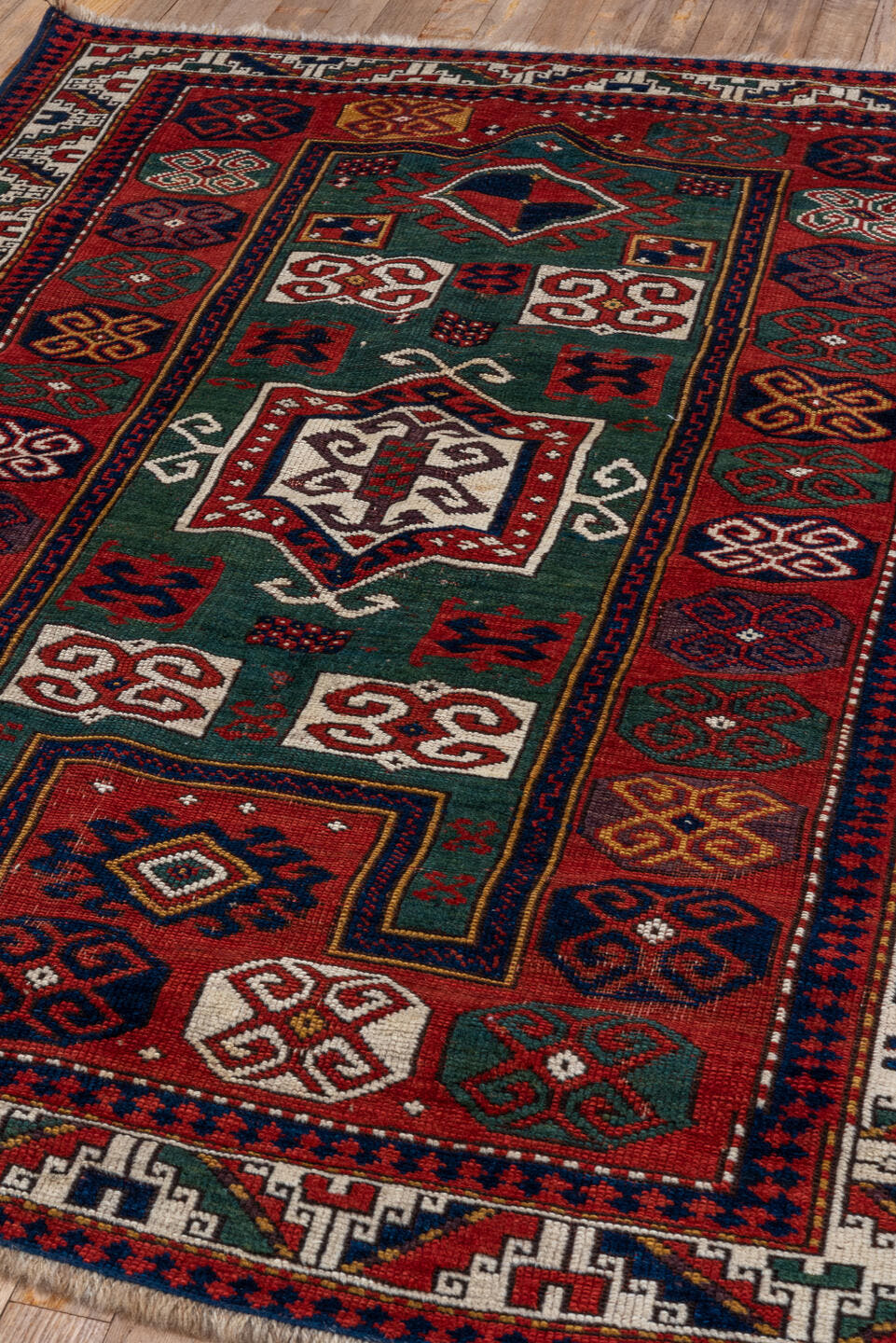 3' x 5' one-of-a-kind handmade vintage Kazak small size rug. Color palette: red, ivory, navy, teal, crimson, sage, burgundy