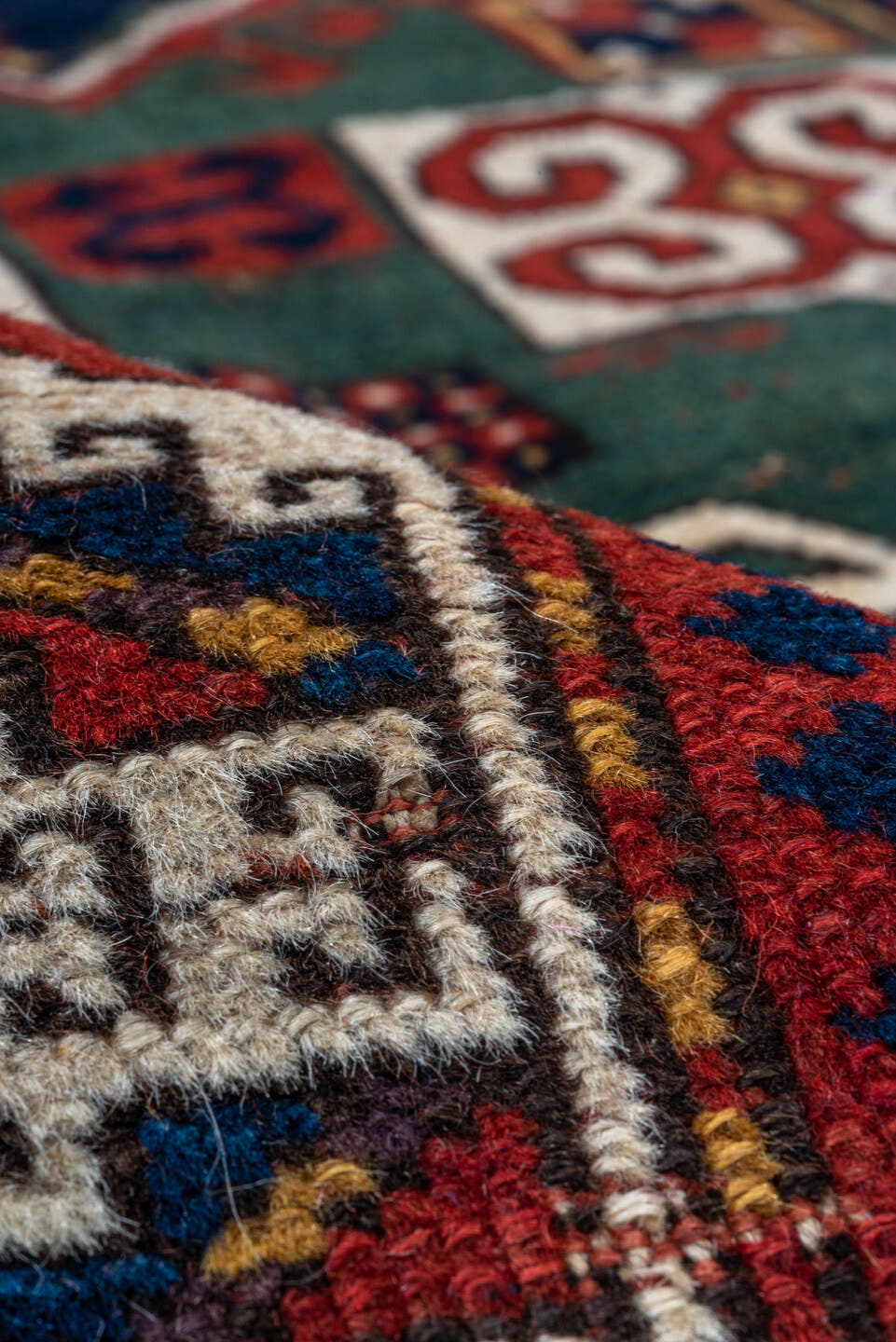 3' x 5' one-of-a-kind handmade vintage Kazak small size rug. Color palette: red, ivory, navy, teal, crimson, sage, burgundy