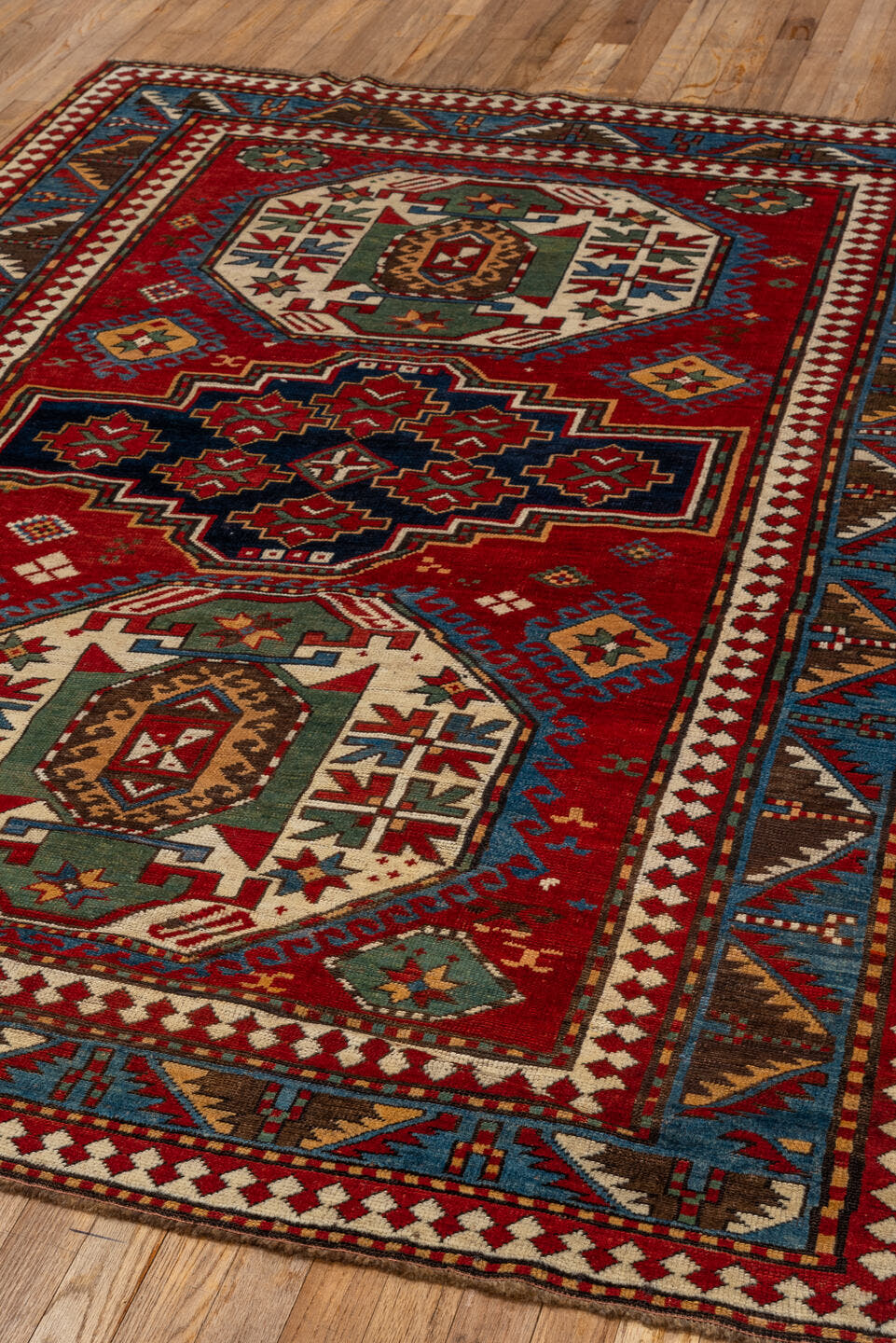 5' x 7' one-of-a-kind handmade vintage Kazak rug. Color palette: red, ivory, sky_blue, navy, brown, sage, camel, light blue