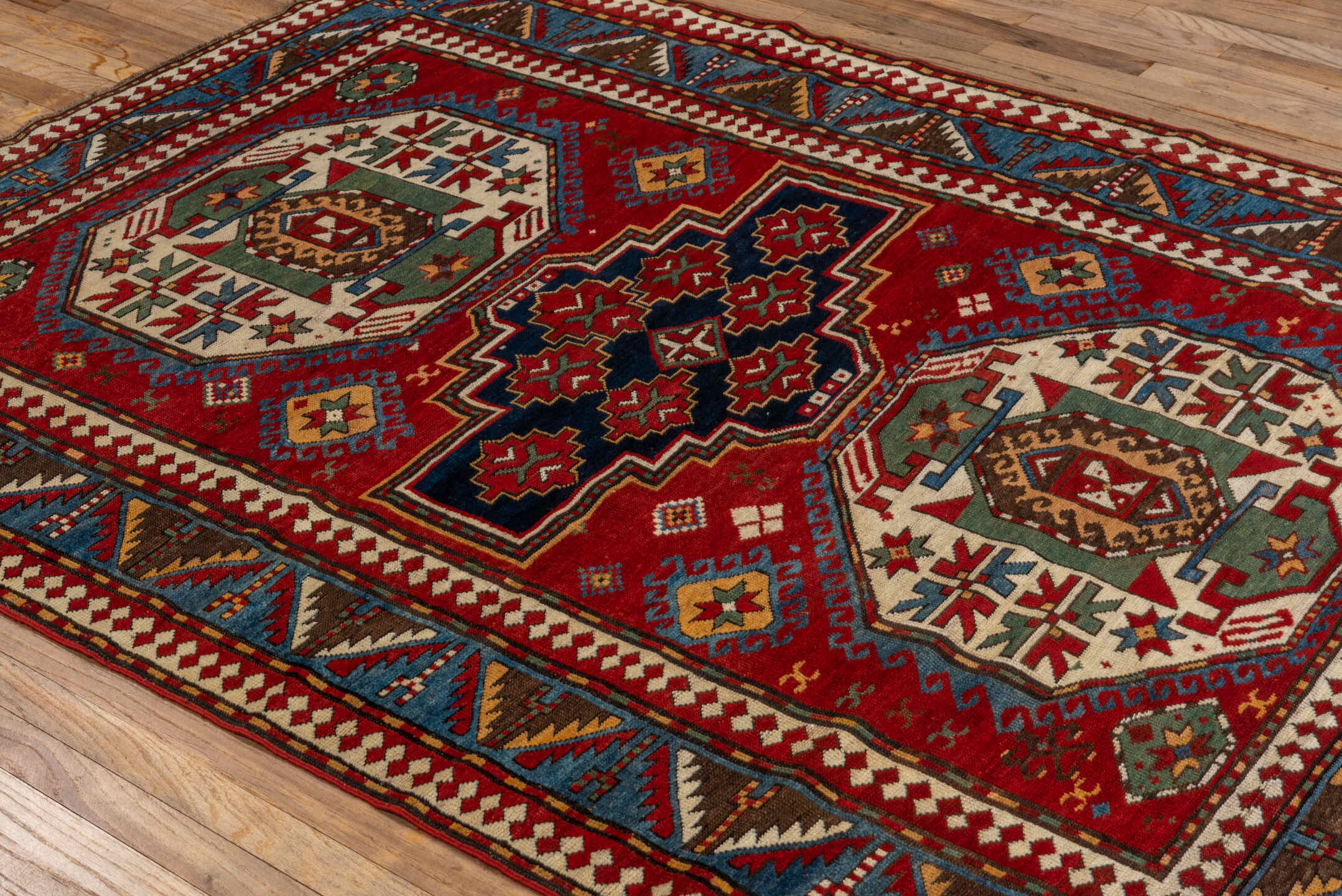 5' x 7' one-of-a-kind handmade vintage Kazak rug. Color palette: red, ivory, sky_blue, navy, brown, sage, camel, light blue