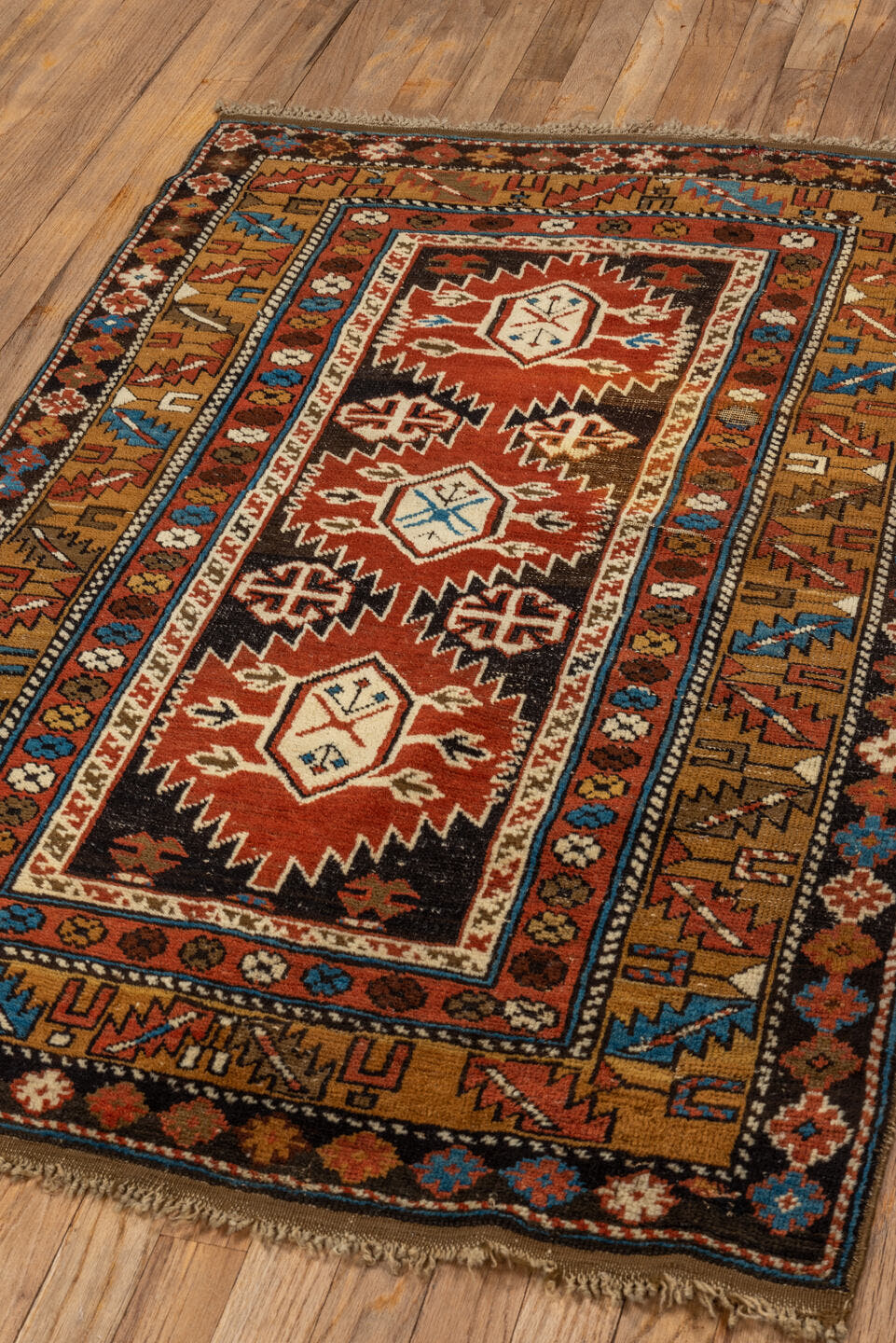 3' x 4' one-of-a-kind handmade vintage Shirvan small size rug. Color palette: rust, camel, ivory, black, sky blue