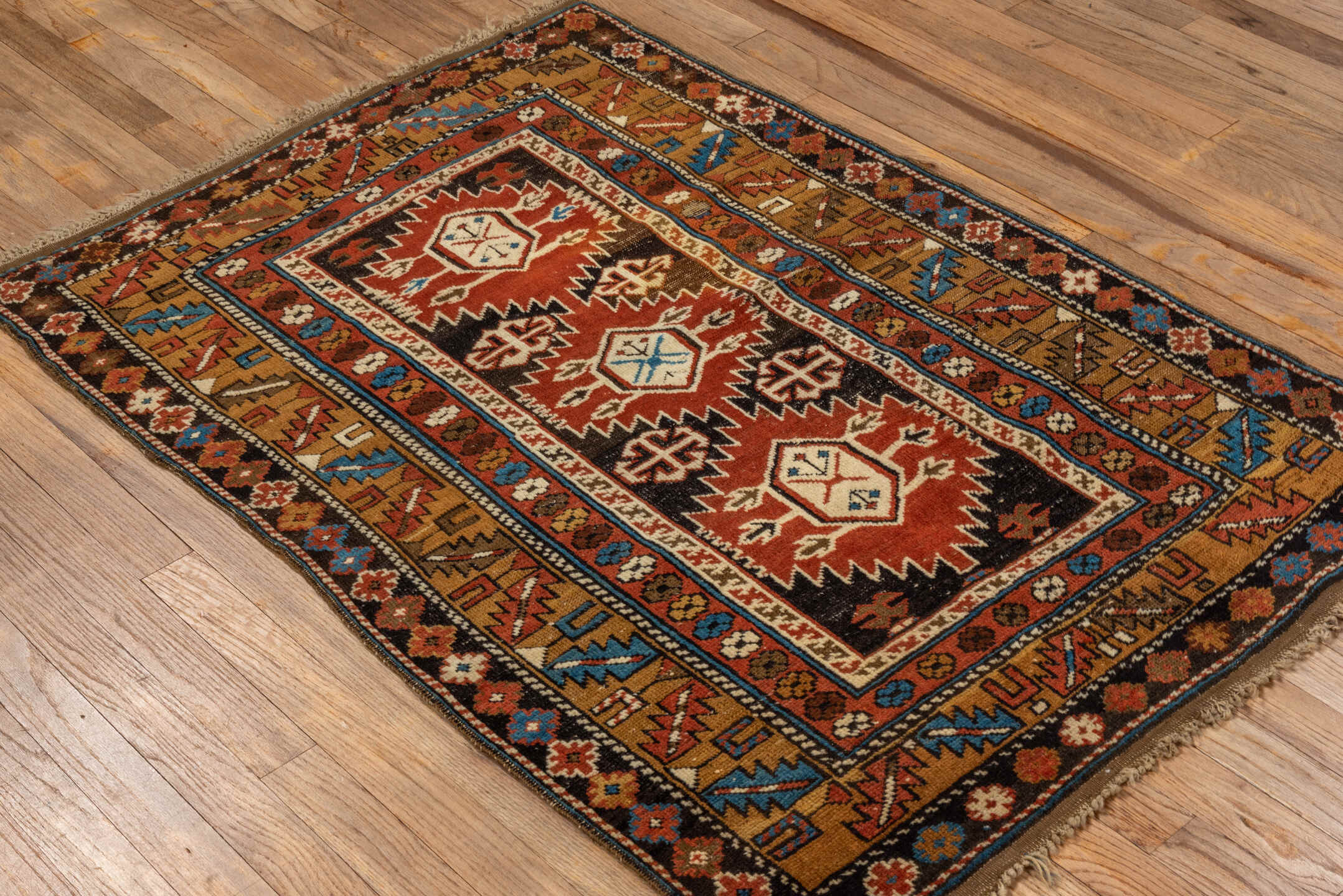 3' x 4' one-of-a-kind handmade vintage Shirvan small size rug. Color palette: rust, camel, ivory, black, sky blue
