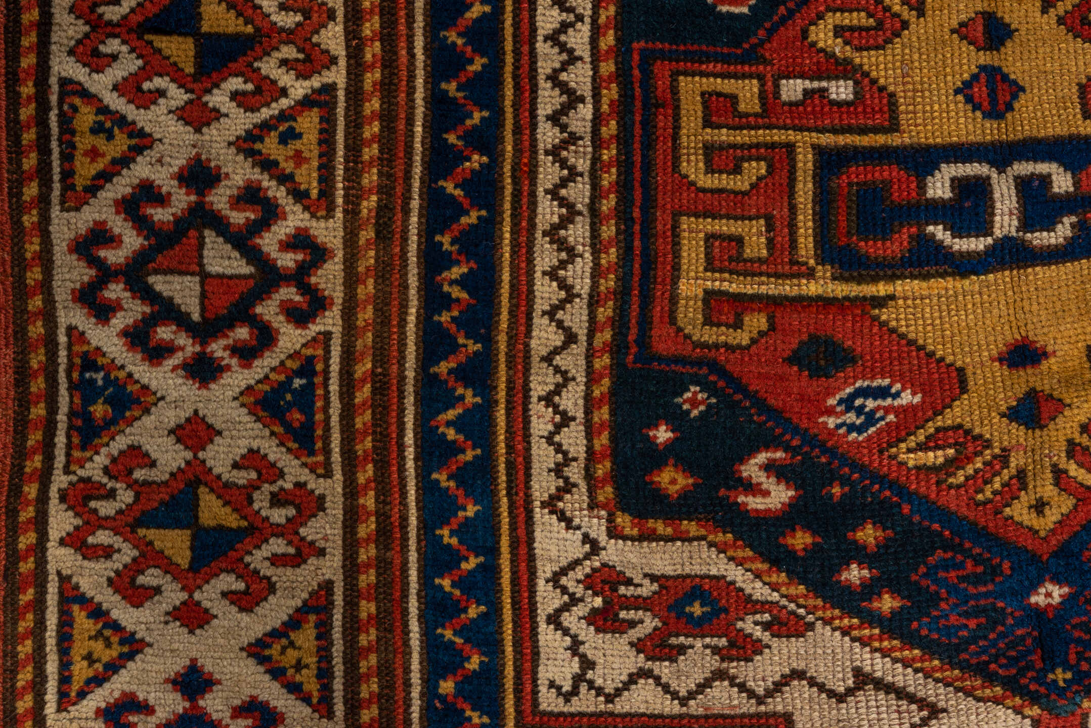 3' x 6' one-of-a-kind handmade vintage Kazak small size rug. Color palette: rust, ivory, navy, gold, crimson, camel, teal