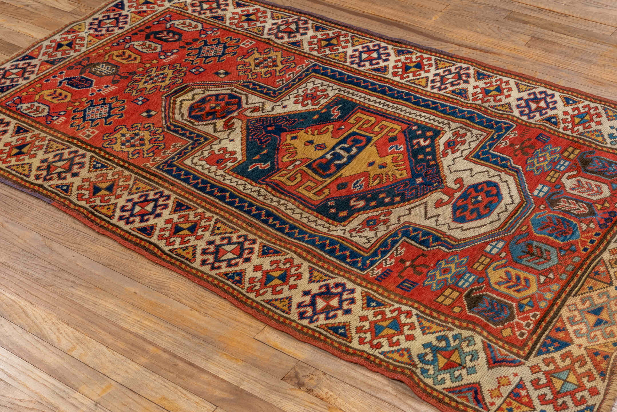 3' x 6' one-of-a-kind handmade vintage Kazak small size rug. Color palette: rust, ivory, navy, gold, crimson, camel, teal