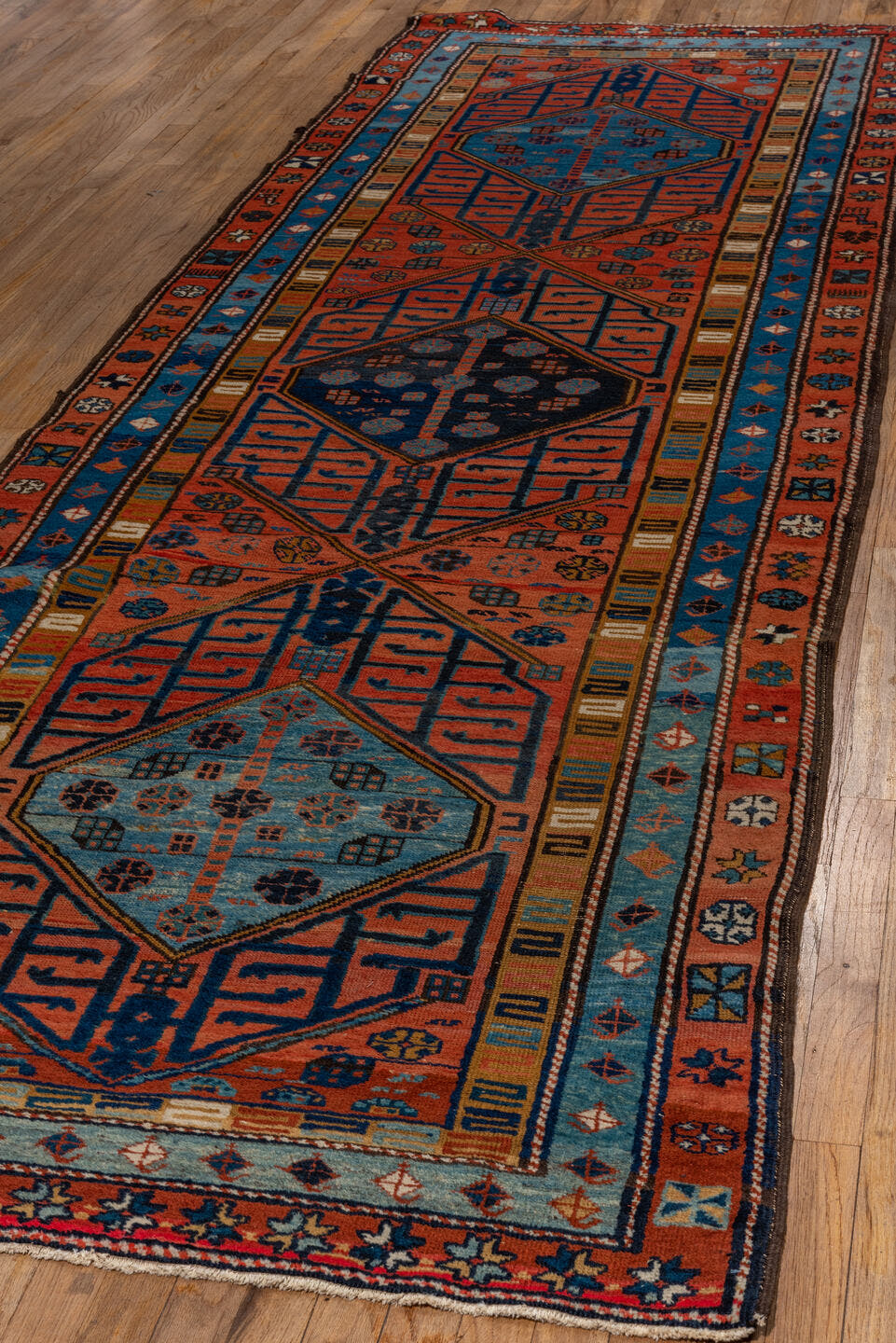 3' x 12' one-of-a-kind handmade vintage NW Persian runner rug. Color palette: rust, sky blue, navy, ivory, coral, camel