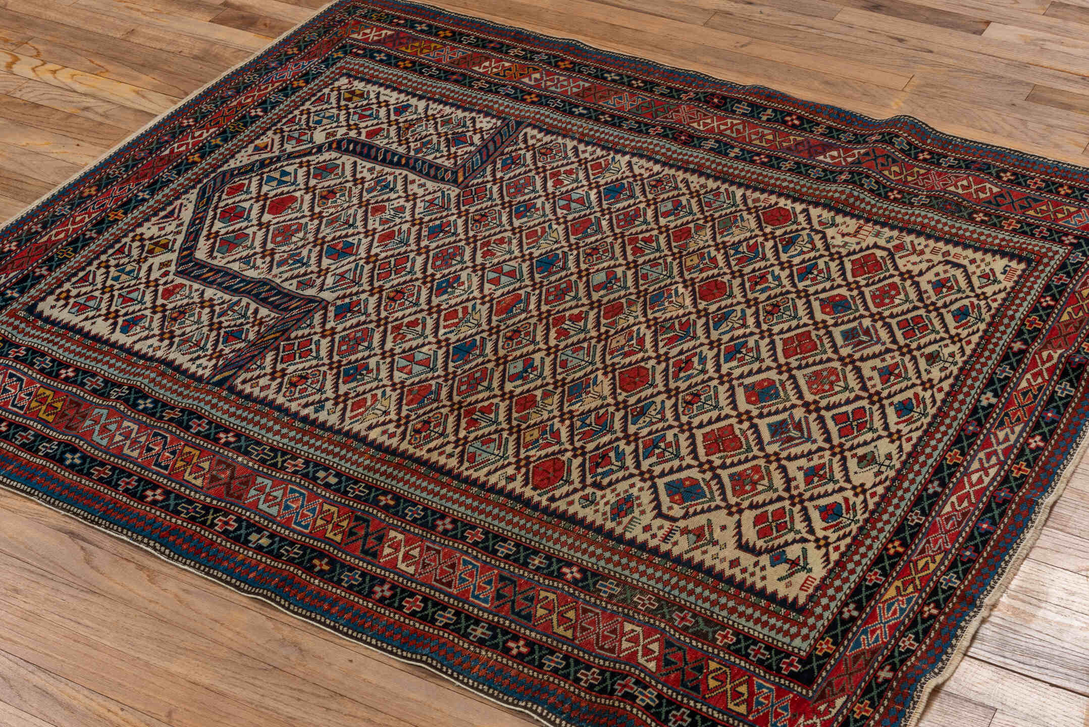 4' x 4' one-of-a-kind handmade vintage Shirvan small size rug. Color palette: ivory, navy, rust, sky blue, crimson, camel