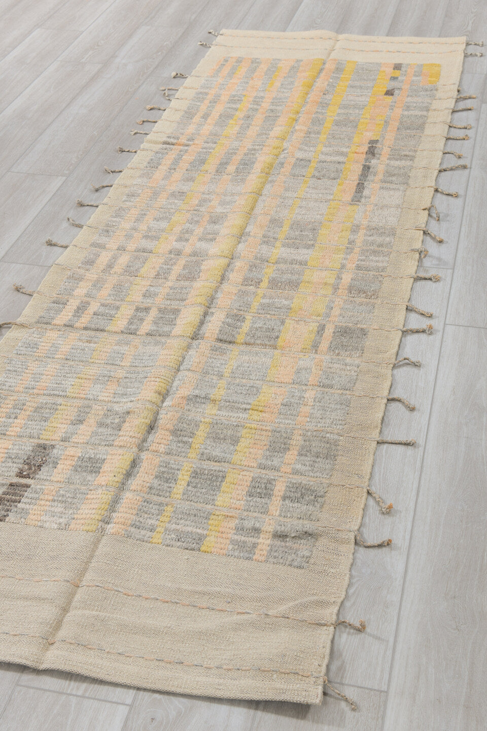 2' x 9' one-of-a-kind handmade vintage Tulu runner rug. Color palette: ivory, pale gold, gray, charcoal, cream, gold, black