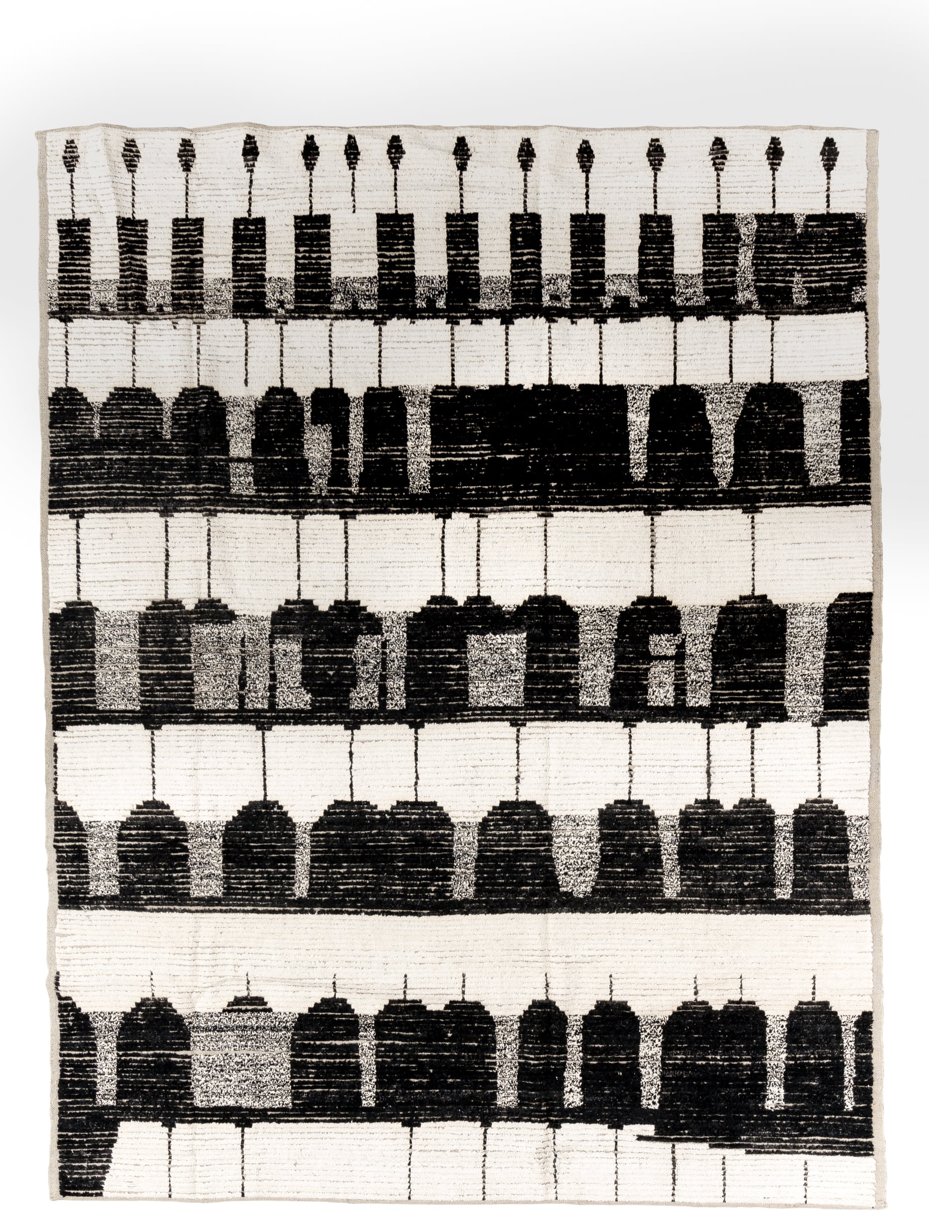 7' x 9' one-of-a-kind handmade vintage Tulu rug. Color palette: ivory, black, charcoal, gray