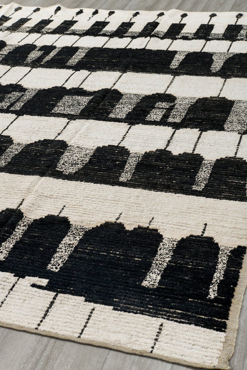 7' x 9' one-of-a-kind handmade vintage Tulu rug. Color palette: ivory, black, charcoal, gray