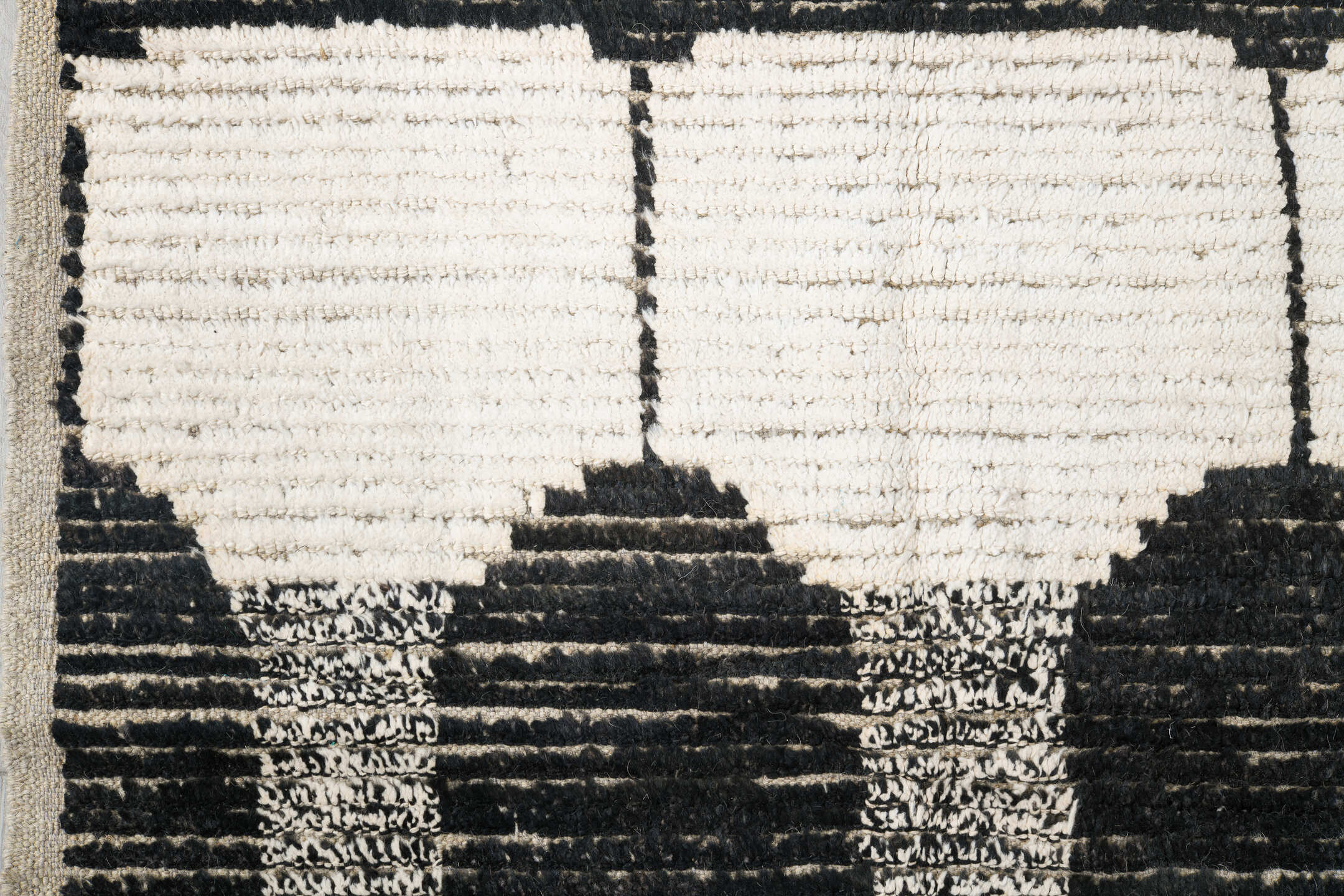 7' x 9' one-of-a-kind handmade vintage Tulu rug. Color palette: ivory, black, charcoal, gray