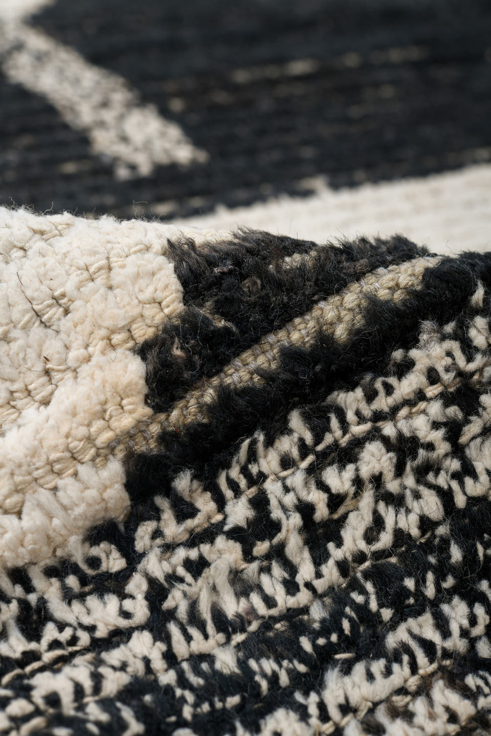 7' x 9' one-of-a-kind handmade vintage Tulu rug. Color palette: ivory, black, charcoal, gray