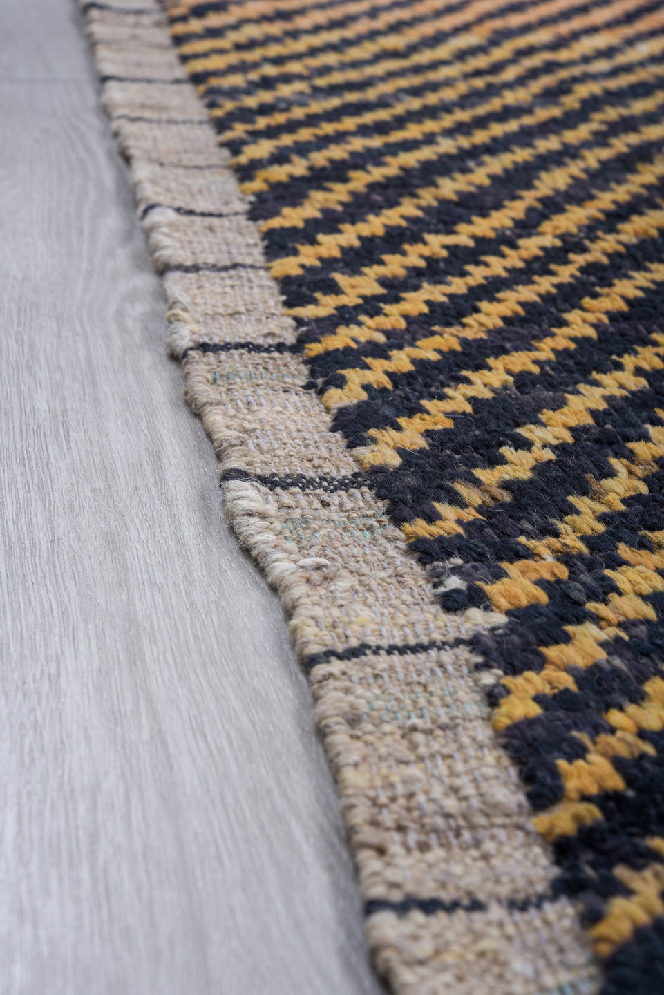 7' x 9' one-of-a-kind handmade vintage Tulu rug. Color palette: charcoal, camel, ivory, gray, black, beige