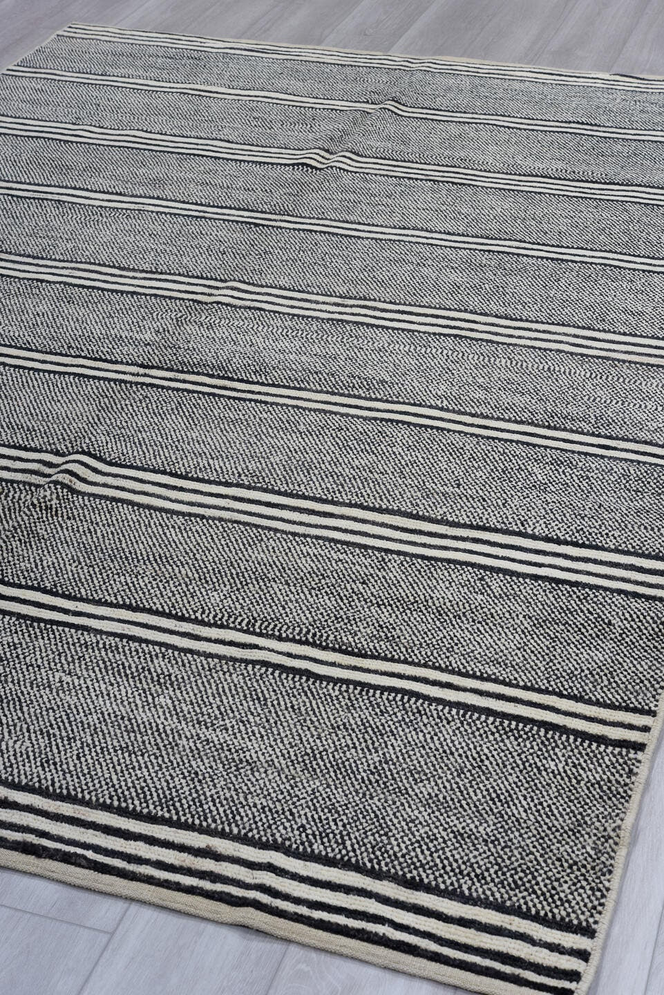 6' x 9' one-of-a-kind handmade vintage Tulu medium size rug. Color palette: charcoal, ivory, gray, black